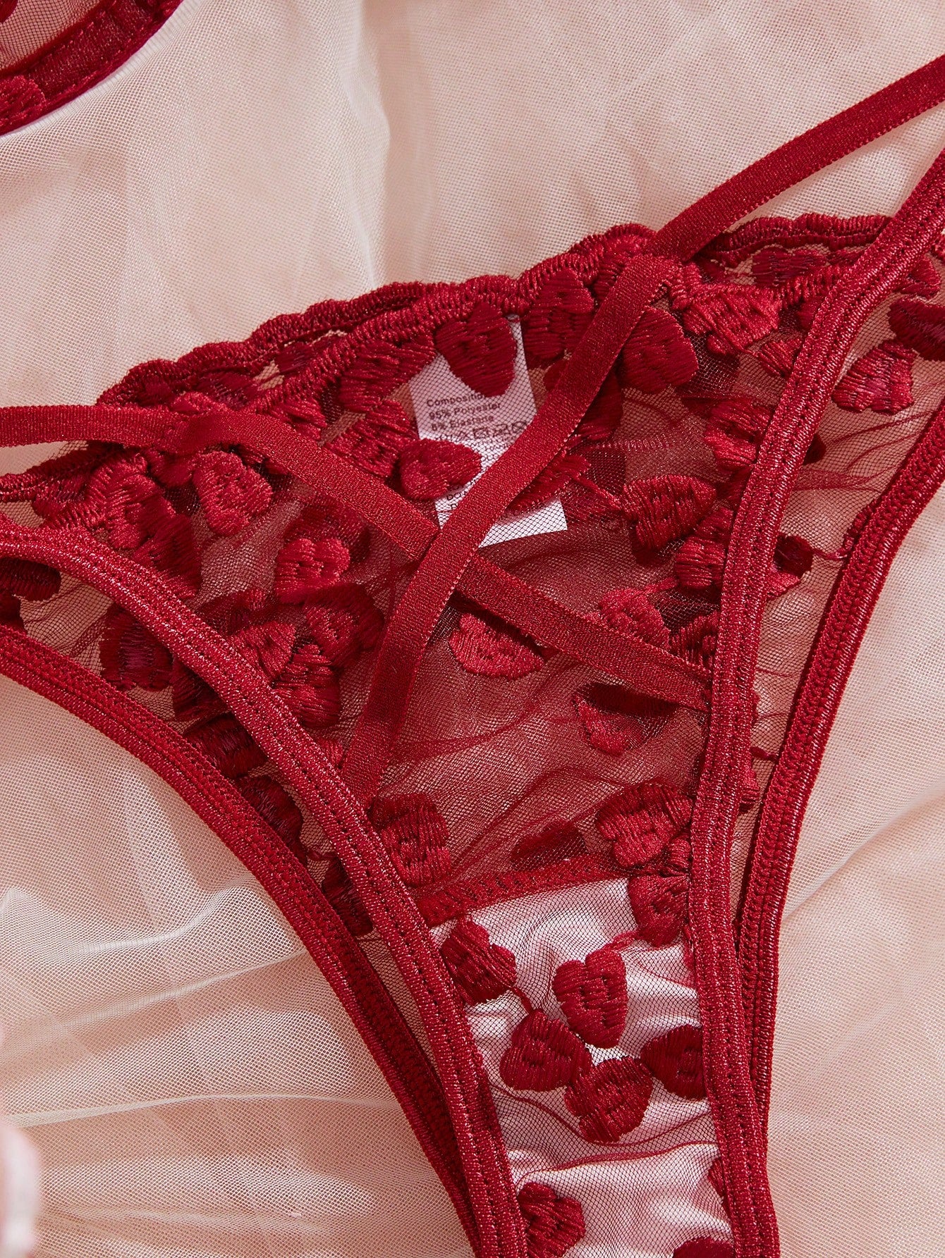Burgundy women’s 2-piece lingerie set with heart mesh splice details, embroidery, sheer cut-out design, underwire demi bra with adjustable spaghetti straps, and matching mid-rise thong.