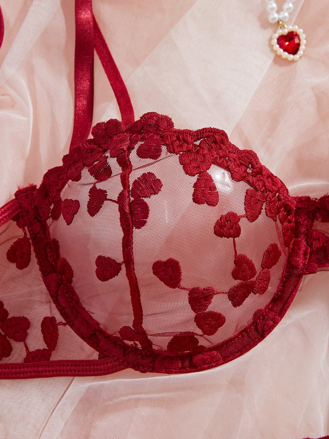 Burgundy women’s 2-piece lingerie set with heart mesh splice details, embroidery, sheer cut-out design, underwire demi bra with adjustable spaghetti straps, and matching mid-rise thong.
