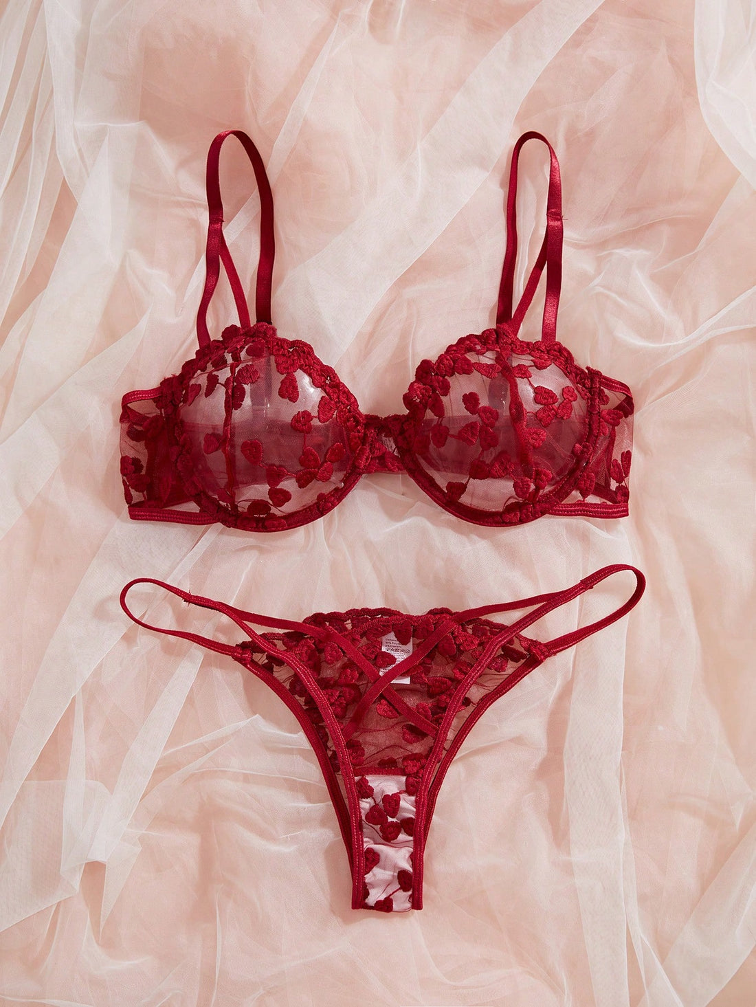 Burgundy women’s 2-piece lingerie set with heart mesh splice details, embroidery, sheer cut-out design, underwire demi bra with adjustable spaghetti straps, and matching mid-rise thong.