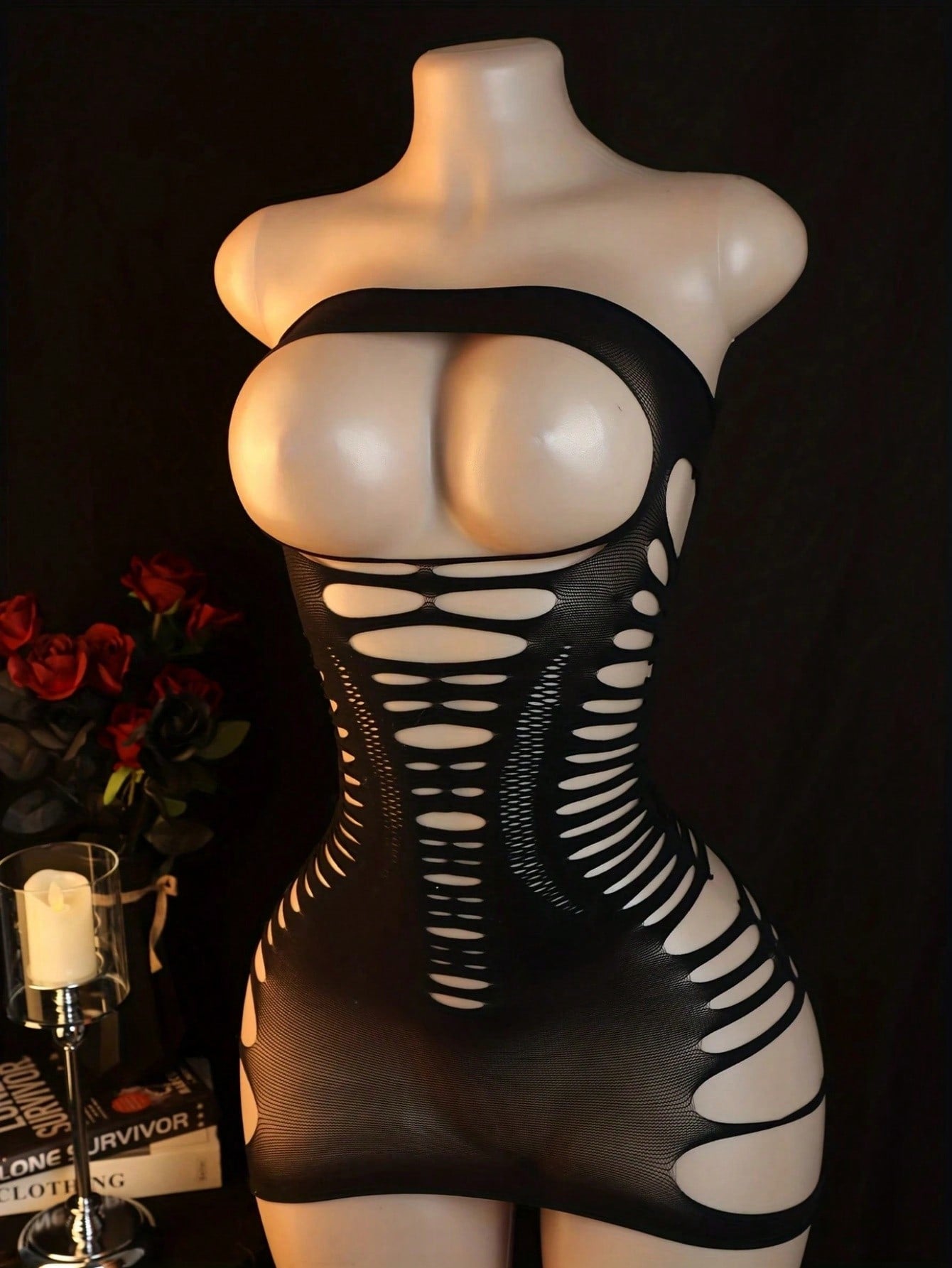 Black women’s one-piece mesh bodysuit with a strapless design, stand collar, long sleeves, and backless cut-out detailing. Short length with high-stretch knitted fabric, suitable for party and festival wear.