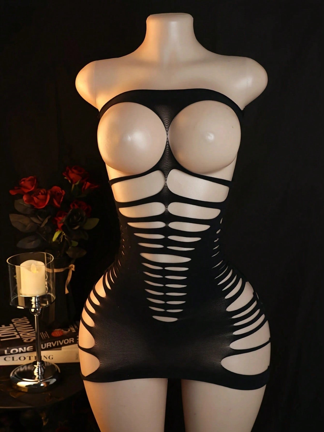 Black women’s one-piece mesh bodysuit with a strapless design, stand collar, long sleeves, and backless cut-out detailing. Short length with high-stretch knitted fabric, suitable for party and festival wear.