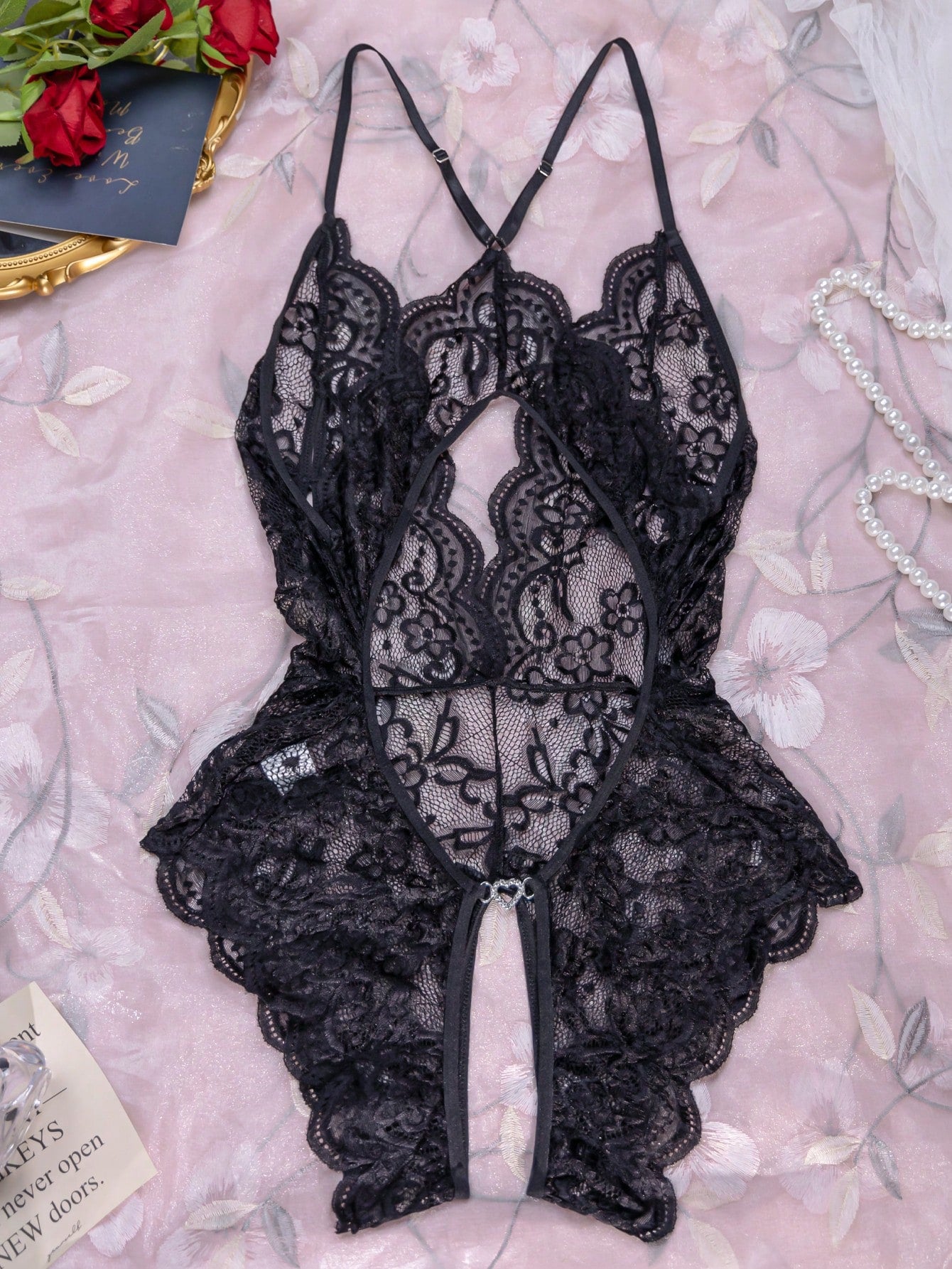 Women’s 1-piece crotchless lace teddy lingerie with a backless design, bowknot detail, open cup, scallop lace trim, spaghetti straps, and crossback straps; semi-sheer, wireless, sleeveless style.