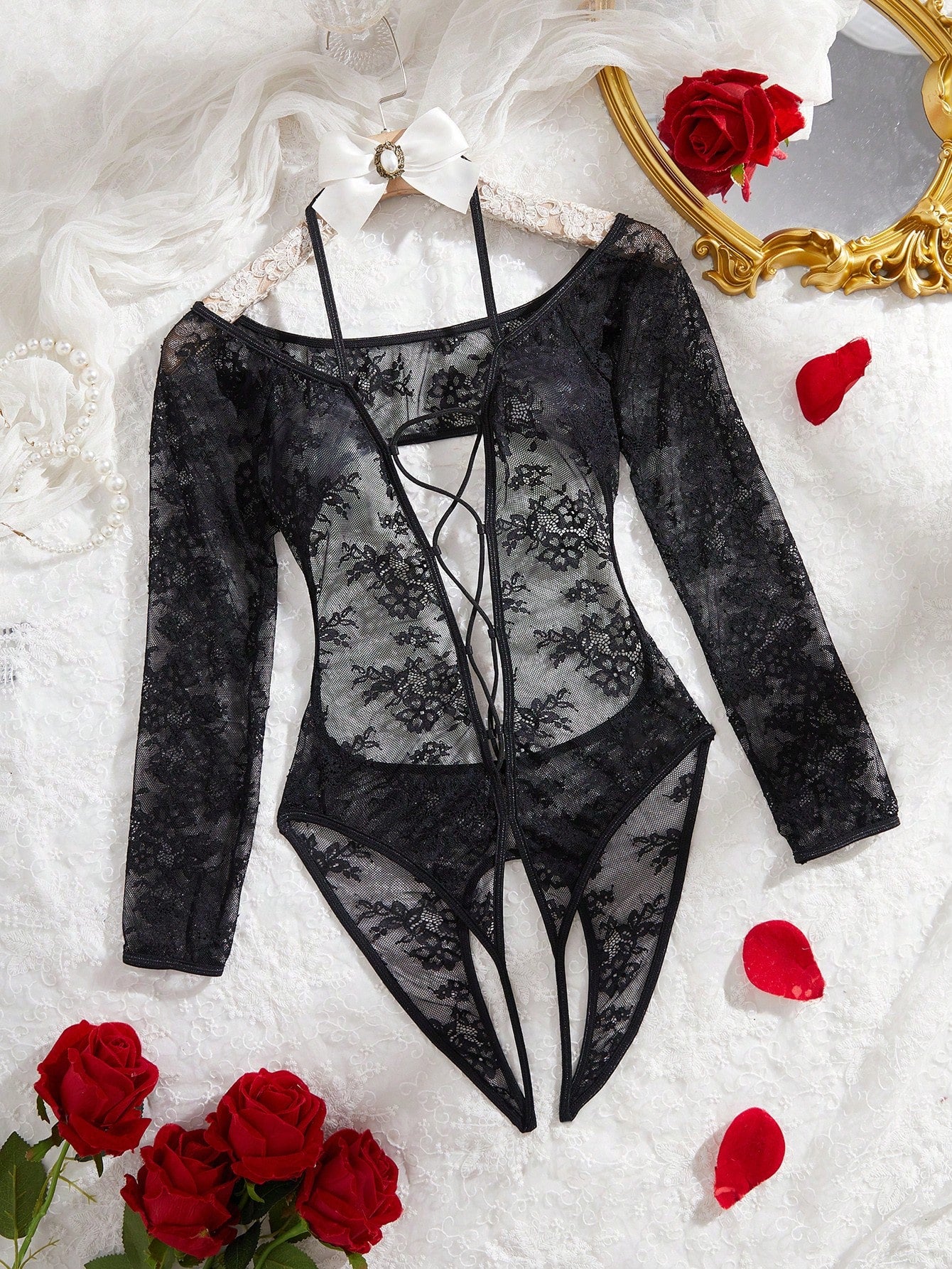 Elegant lace crotchless bodysuit with a backless lace-up design, adjustable spaghetti straps, and a V-string style bottom.