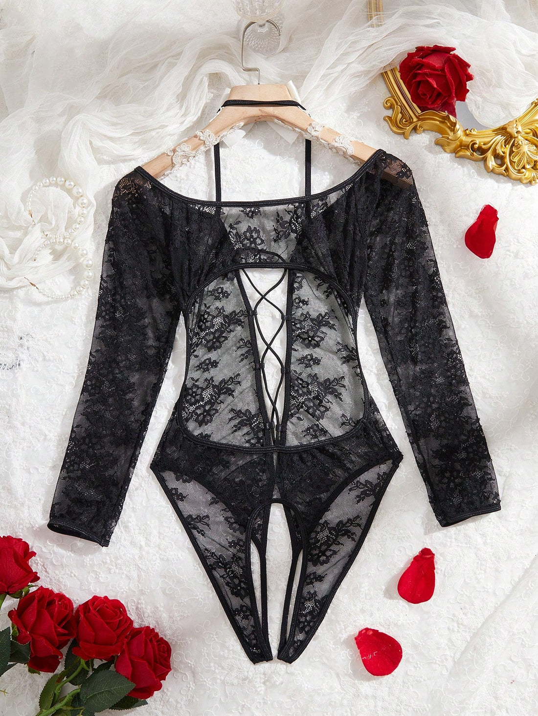Elegant lace crotchless bodysuit with a backless lace-up design, adjustable spaghetti straps, and a V-string style bottom.