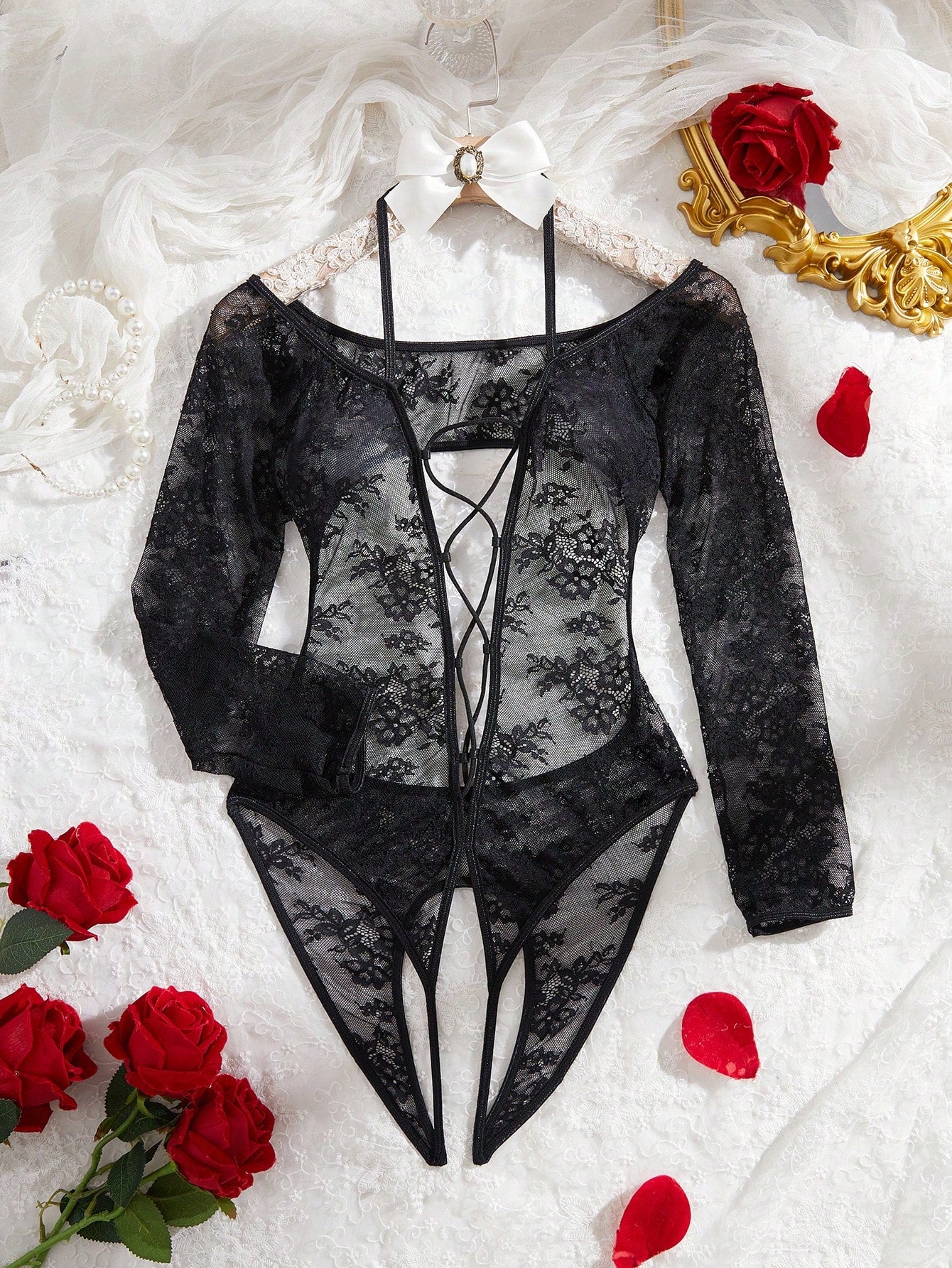Elegant lace crotchless bodysuit with a backless lace-up design, adjustable spaghetti straps, and a V-string style bottom.