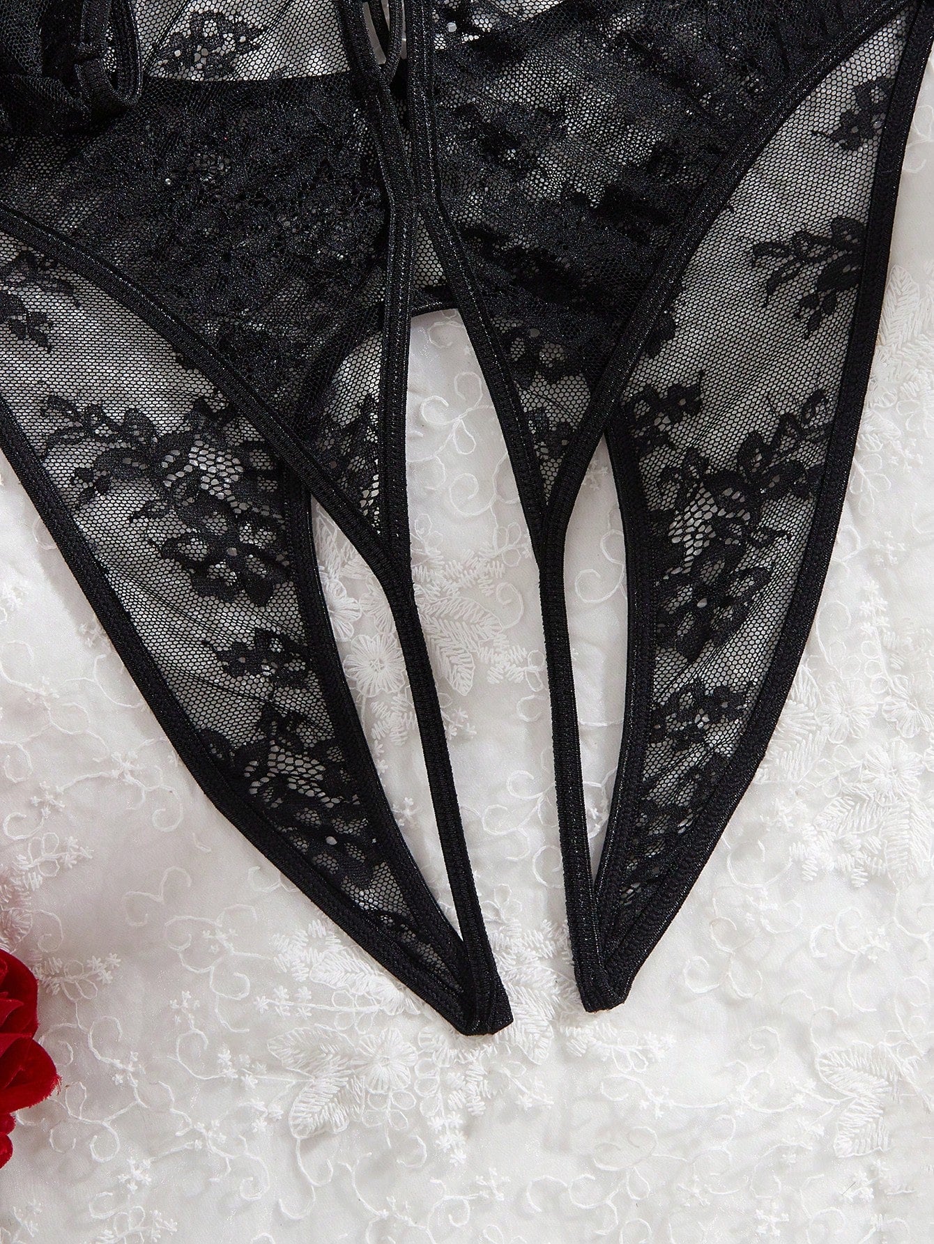 Elegant lace crotchless bodysuit with a backless lace-up design, adjustable spaghetti straps, and a V-string style bottom.