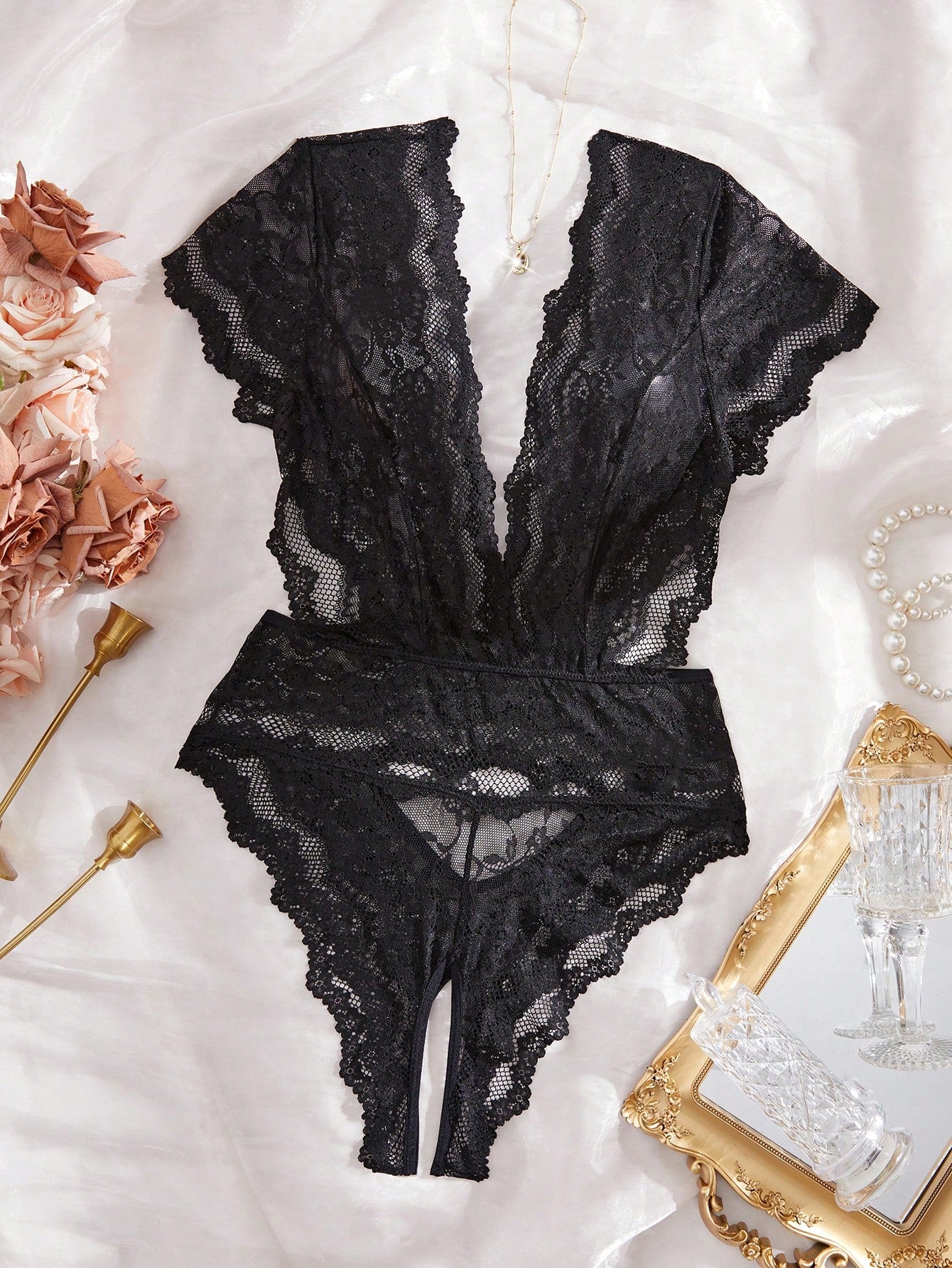 Black floral lace crotchless teddy bodysuit lingerie with sheer cut-out design, deep V neckline, full cup with removable padding, high-rise brief style, and slight stretch fabric.