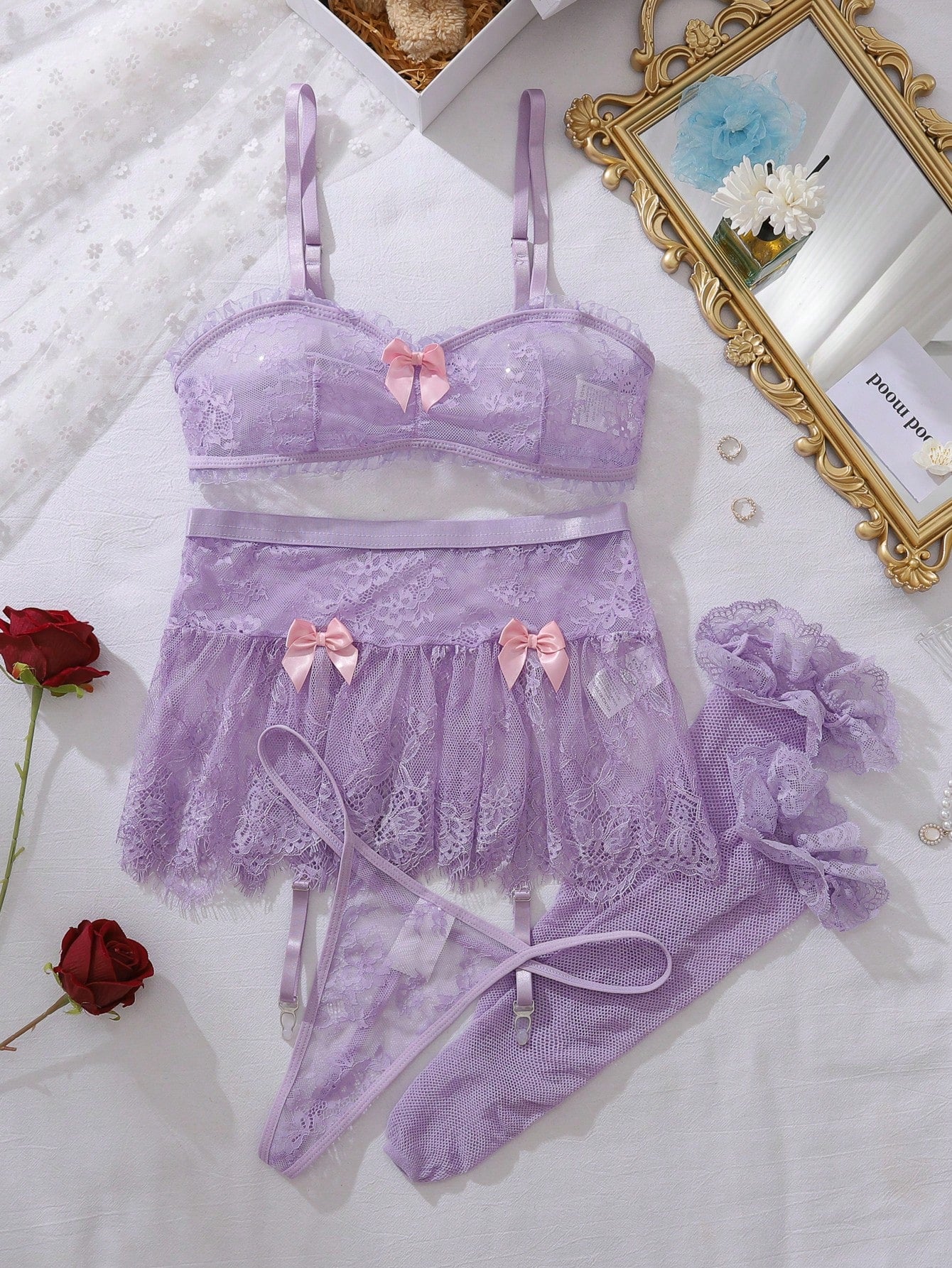 Women’s 5-piece romantic lace lingerie set featuring a sheer bralette with adjustable spaghetti straps, mini skirt, thong, and stockings with contrast lace and bow details.