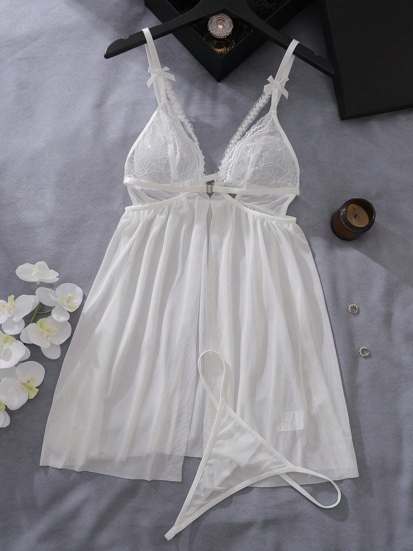 Women’s 2-piece lingerie set featuring a romantic lace patchwork babydoll nightgown with spaghetti straps, bow and cut-out details, and a matching low-rise thong.