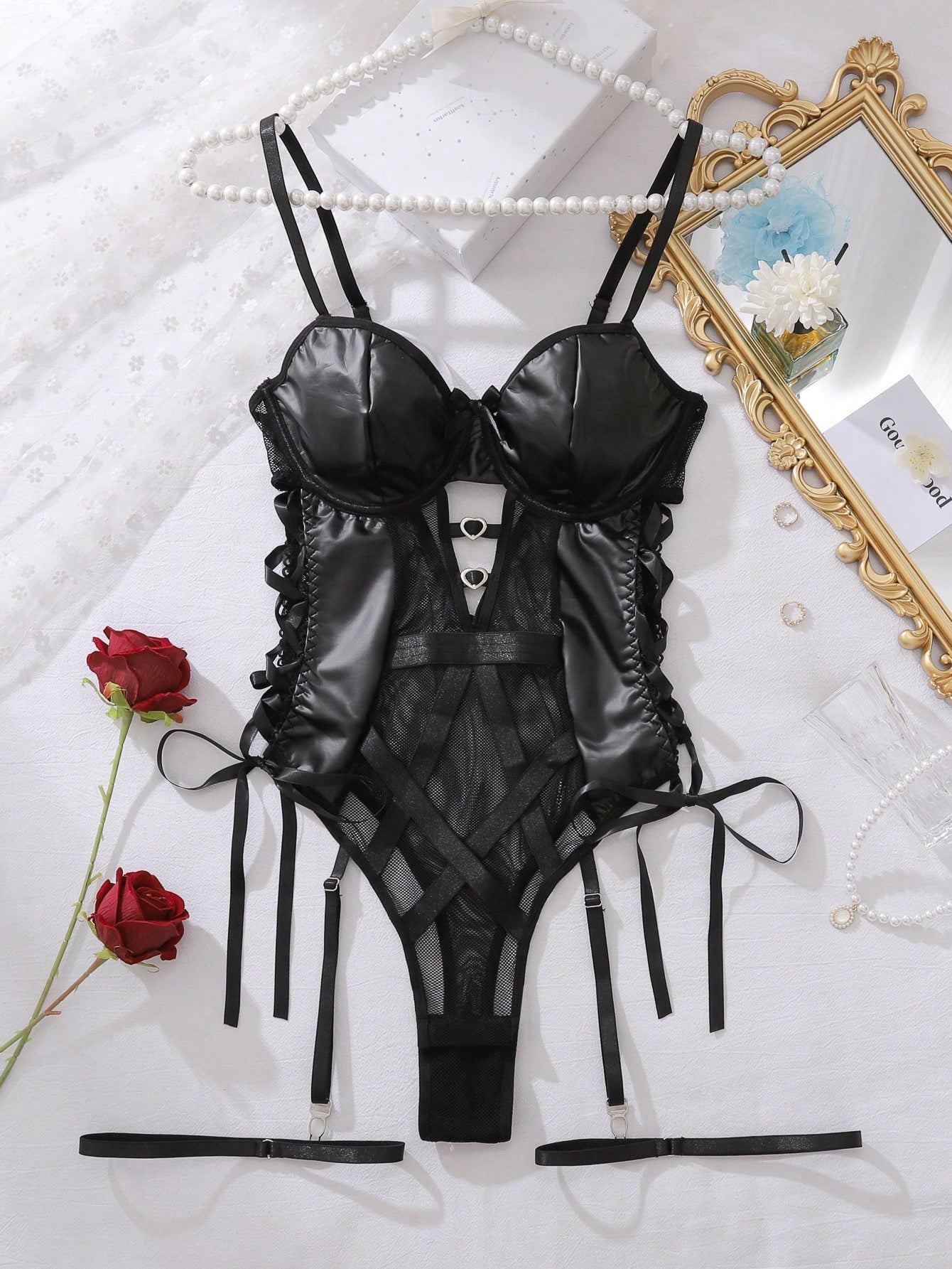 Women’s 3-piece lingerie set including a spliced sheer mesh cami top with hollow-out detail and adjustable spaghetti straps, a low-rise side-tie thong, and a matching garter belt.