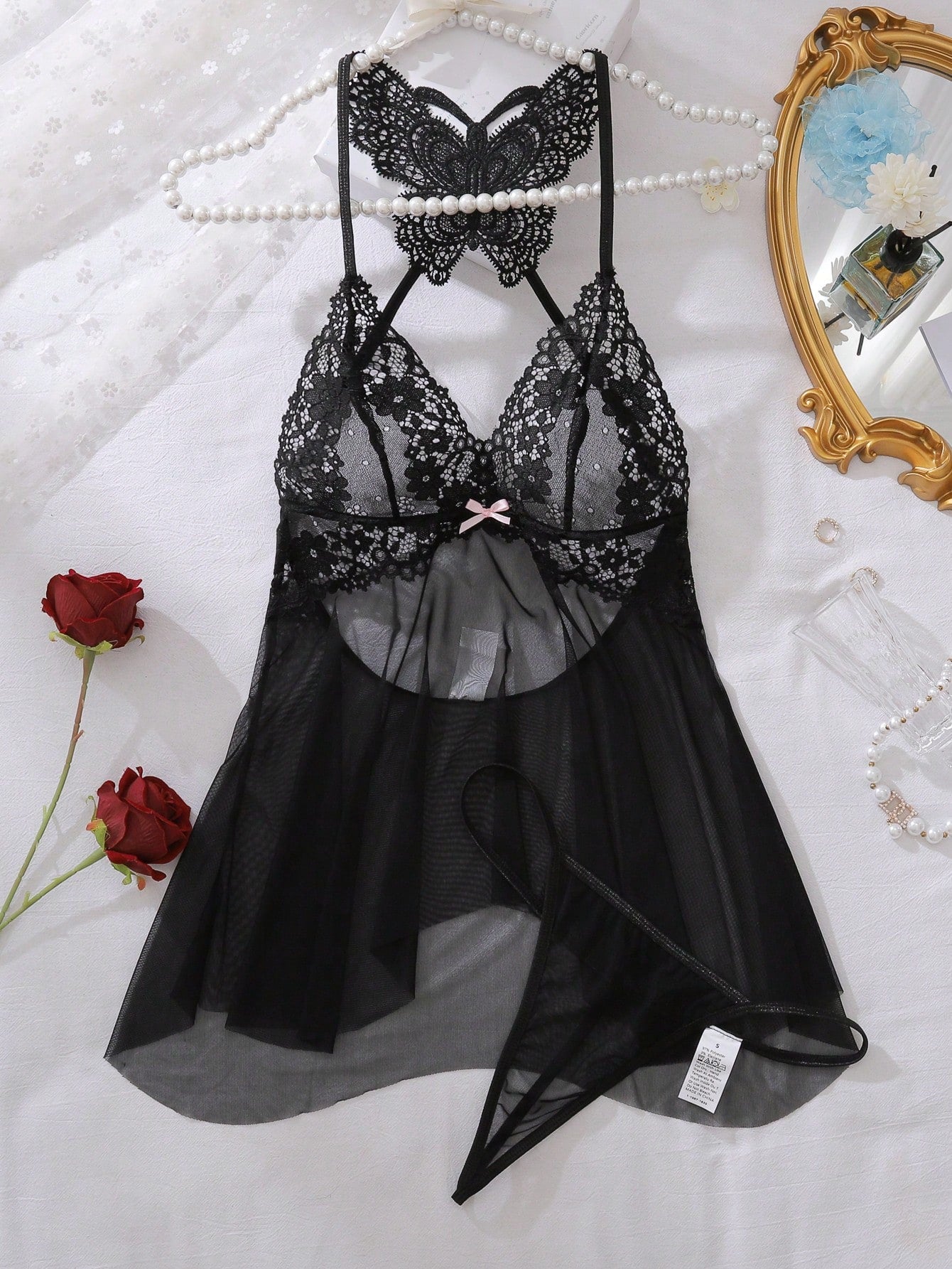 Black contrast lace mesh babydoll lingerie dress with adjustable spaghetti straps, bow detail, triangle cups, and matching V-string thong.