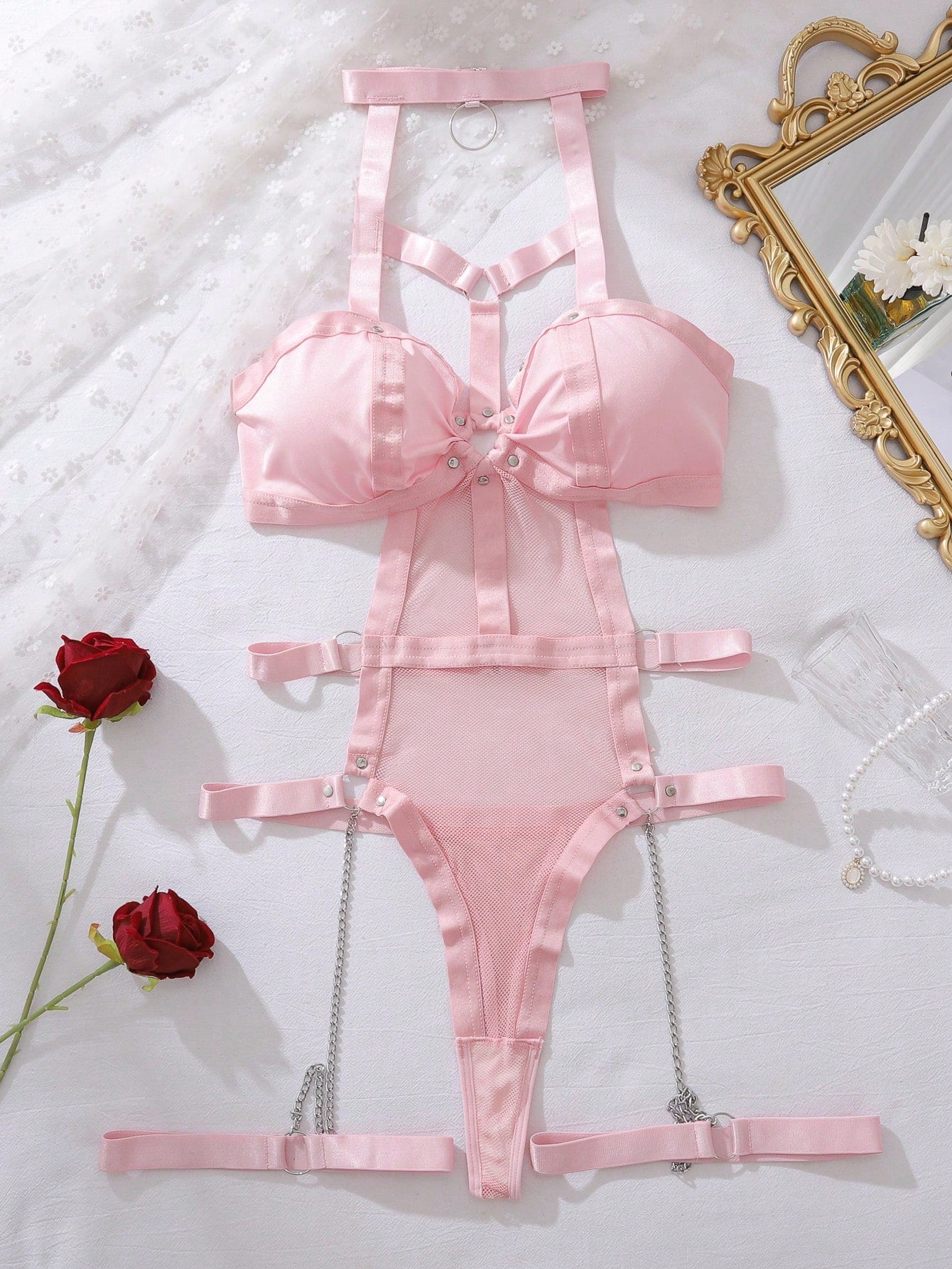 Pink women’s Y2K lingerie set featuring a ring-linked mesh teddy bodysuit with cut-out details, adjustable spaghetti straps, and matching leg rings; 3-piece sexy bodysuit style.