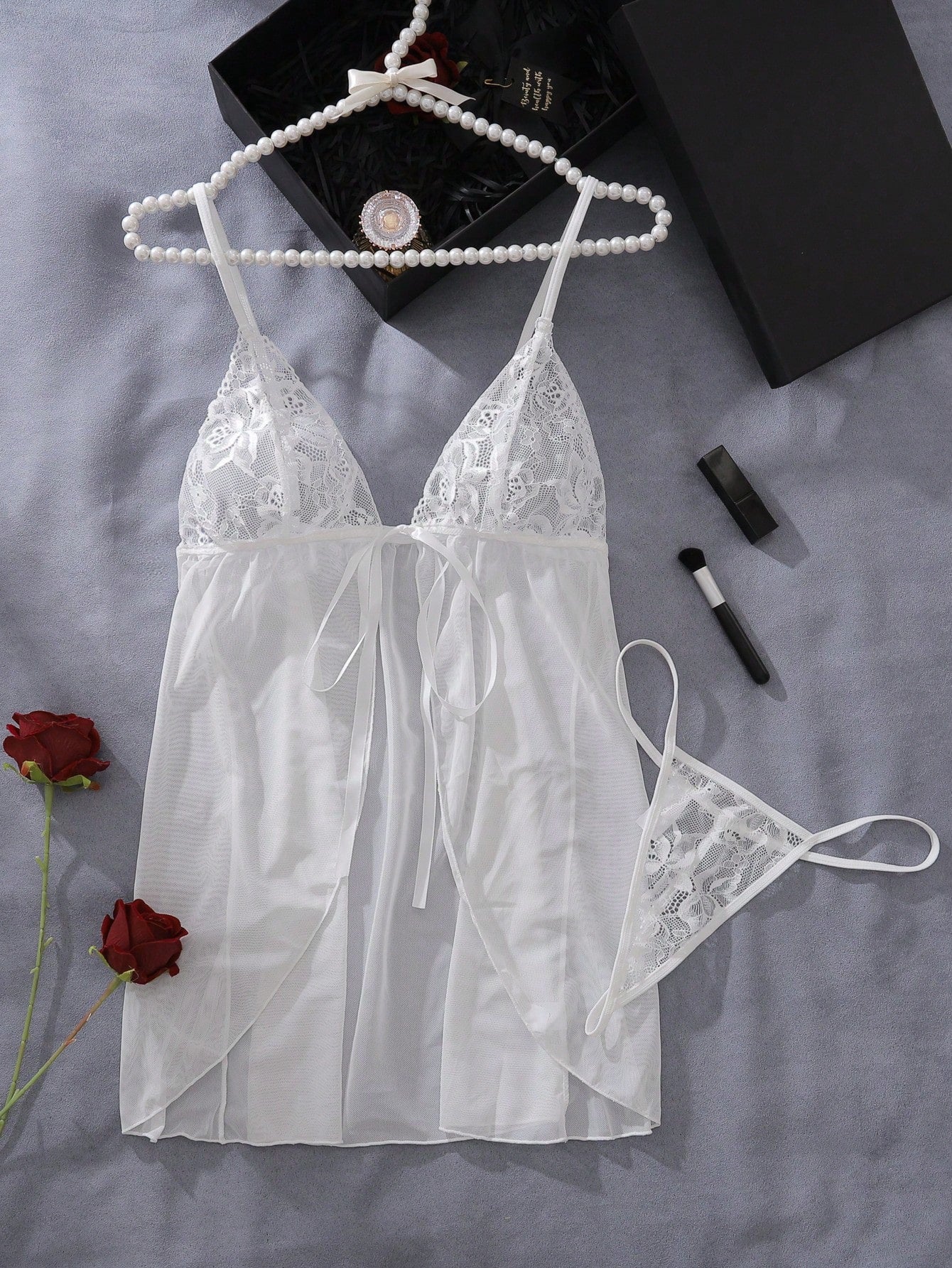 Contrast lace mesh tie-front babydoll lingerie dress set with adjustable spaghetti straps, bow detail, matching bralette, and low-rise V-string panty; semi-sheer plain and baroque pattern design.
