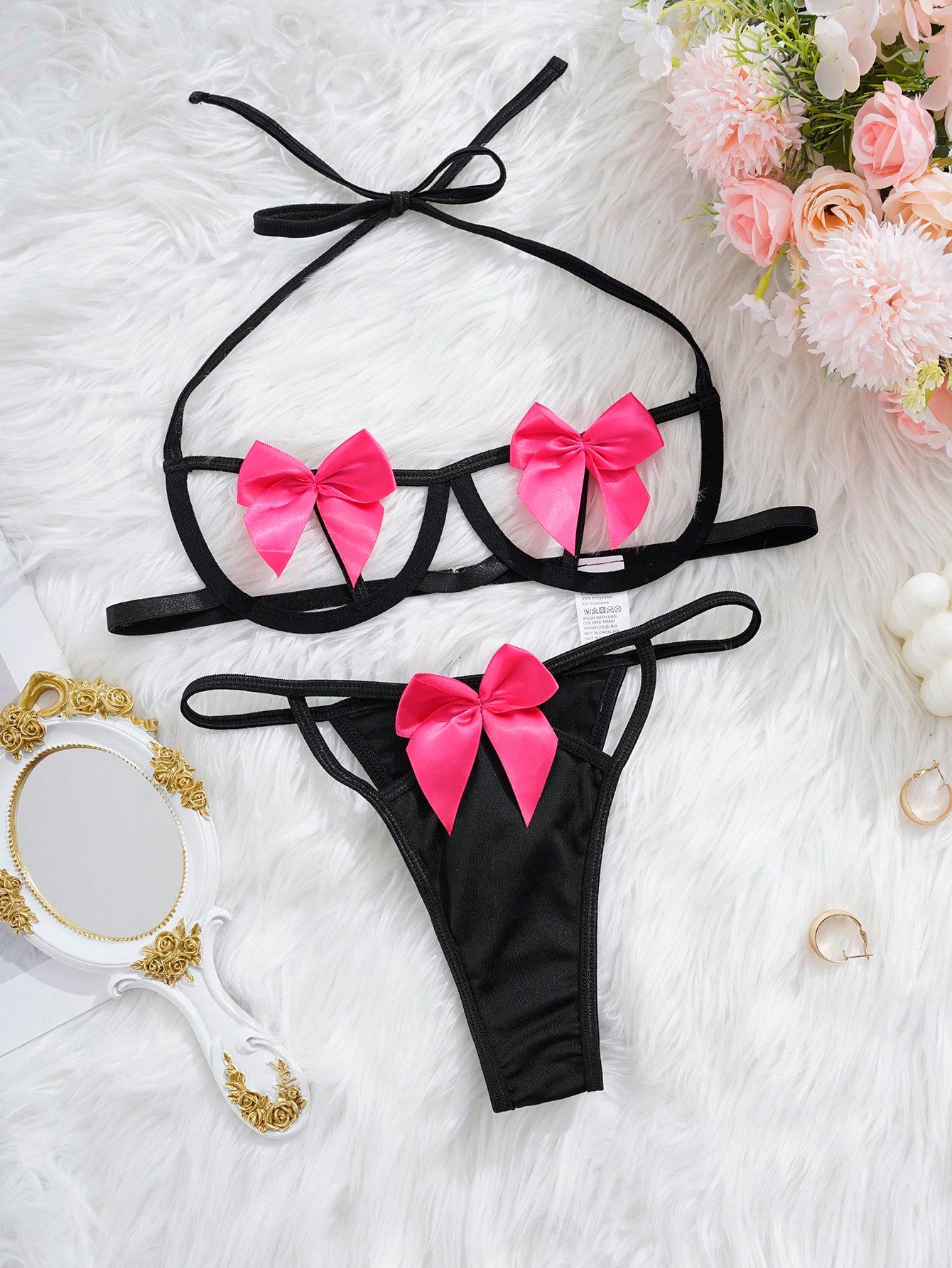 Two-piece women’s sexy lingerie set with bow decoration, cut-out details, halter neckline, underwire demi bra with adjustable straps, and matching low-rise thong.