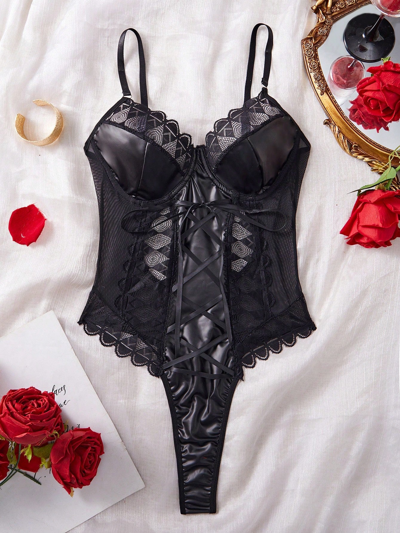 Black women’s sexy bodysuit with contrast lace and mesh panels, PU lace-up detail, spaghetti straps, and underwire support.