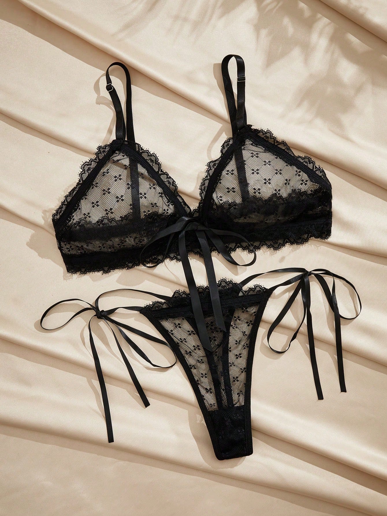 French minimalist 2-piece lingerie set with a sheer wireless bralette featuring contrast lace trim and knot detail, plus a matching mid-rise thong with medium-stretch fabric and adjustable straps.
