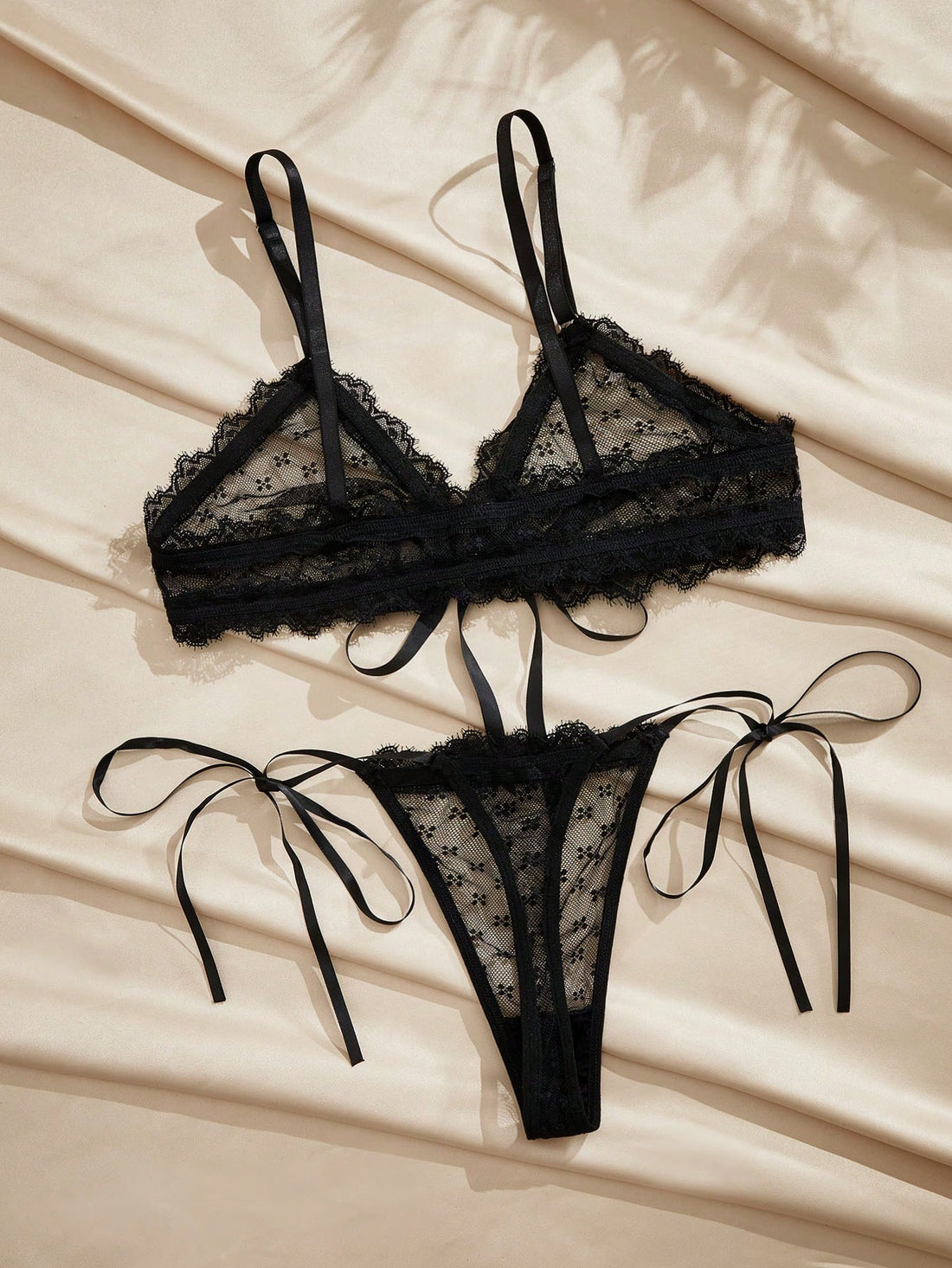 French minimalist 2-piece lingerie set with a sheer wireless bralette featuring contrast lace trim and knot detail, plus a matching mid-rise thong with medium-stretch fabric and adjustable straps.