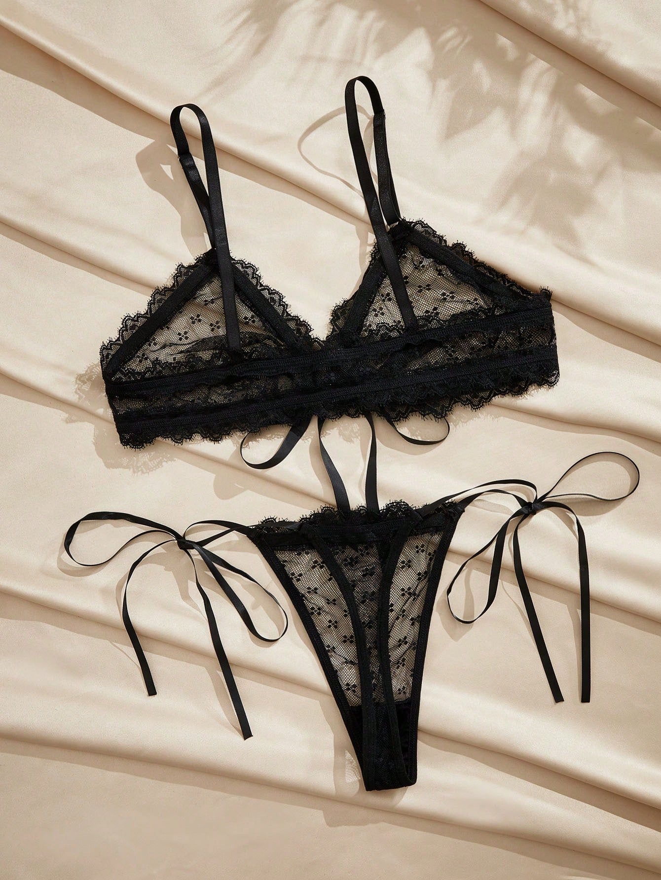 French minimalist 2-piece lingerie set with a sheer wireless bralette featuring contrast lace trim and knot detail, plus a matching mid-rise thong with medium-stretch fabric and adjustable straps.
