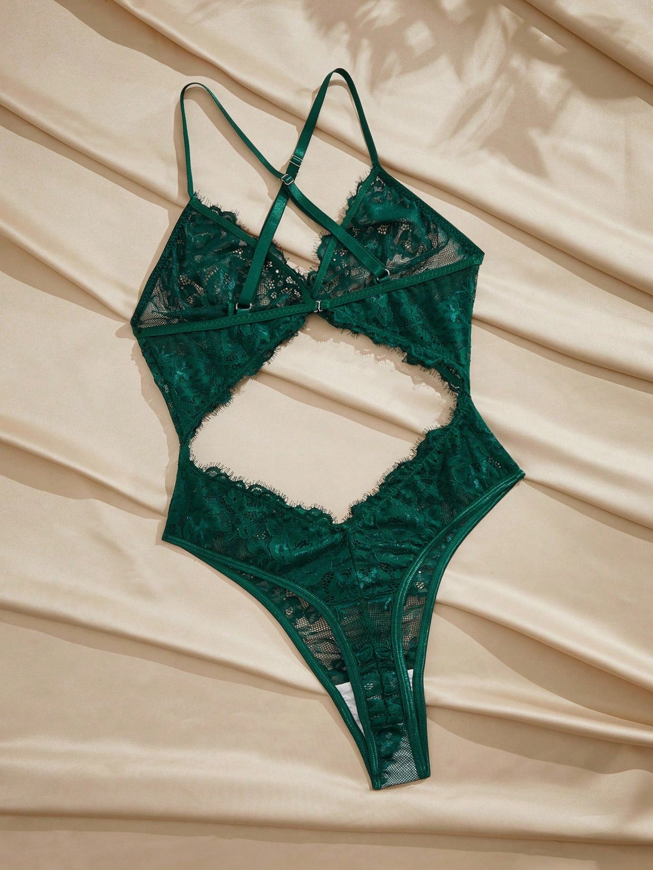 Dark green women’s lace teddy bodysuit set featuring spaghetti straps, backless criss-cross detailing, cut-out accents, and a thong-style high-rise bottom; semi-sheer lace with adjustable straps and wireless bralette support.