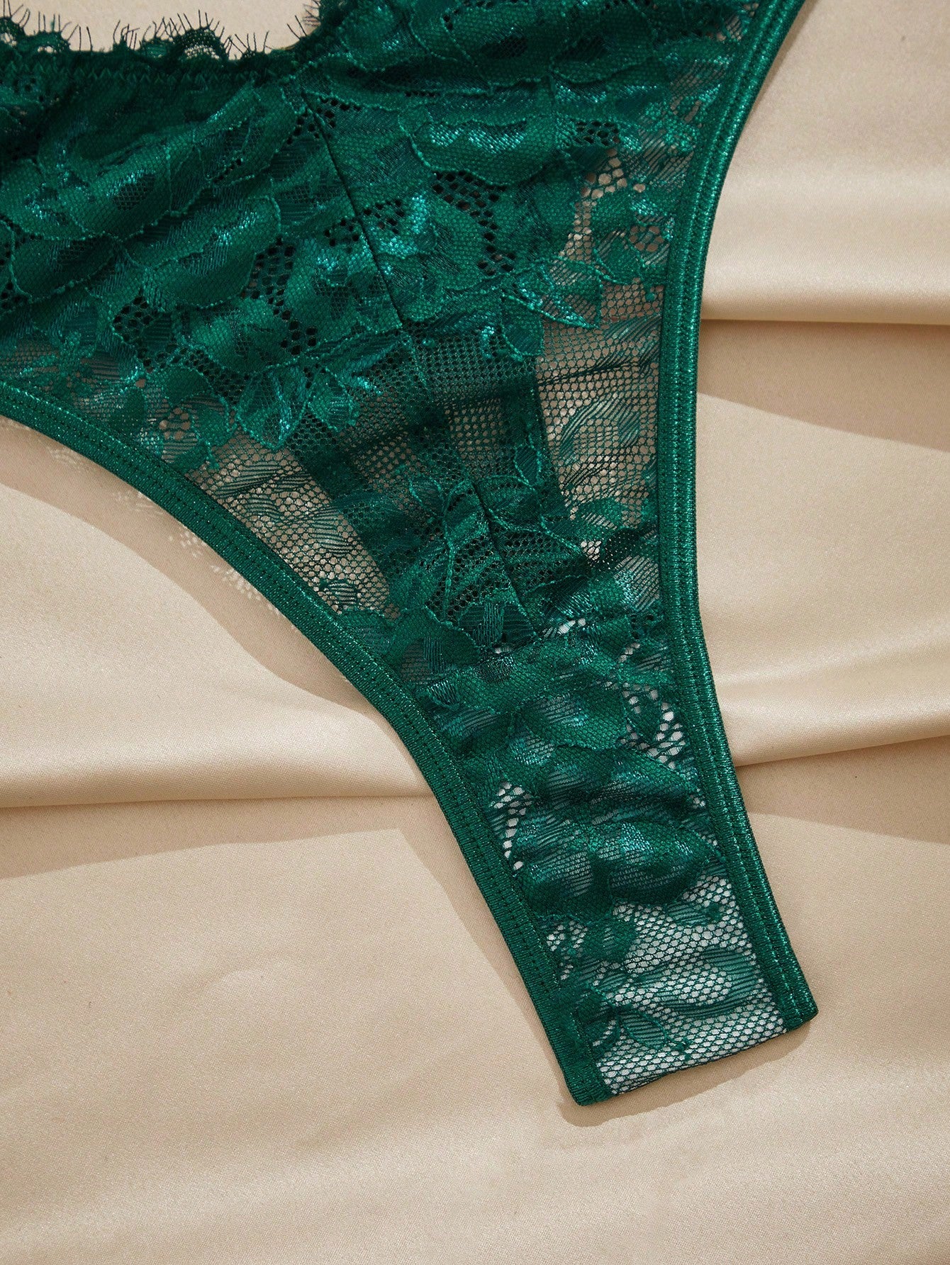 Dark green women’s lace teddy bodysuit set featuring spaghetti straps, backless criss-cross detailing, cut-out accents, and a thong-style high-rise bottom; semi-sheer lace with adjustable straps and wireless bralette support.