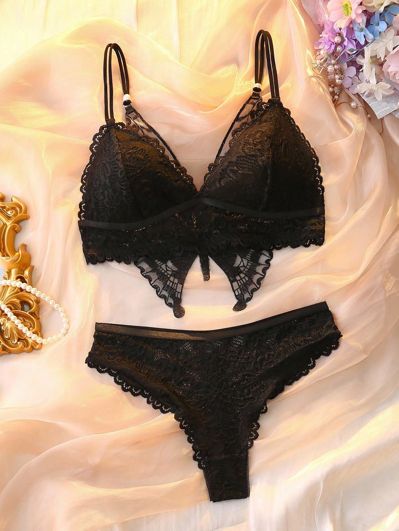 Two-piece floral lace lingerie set with butterfly decor, featuring a sheer unlined wireless backless bra with crossback straps and matching mid-rise brief panties.