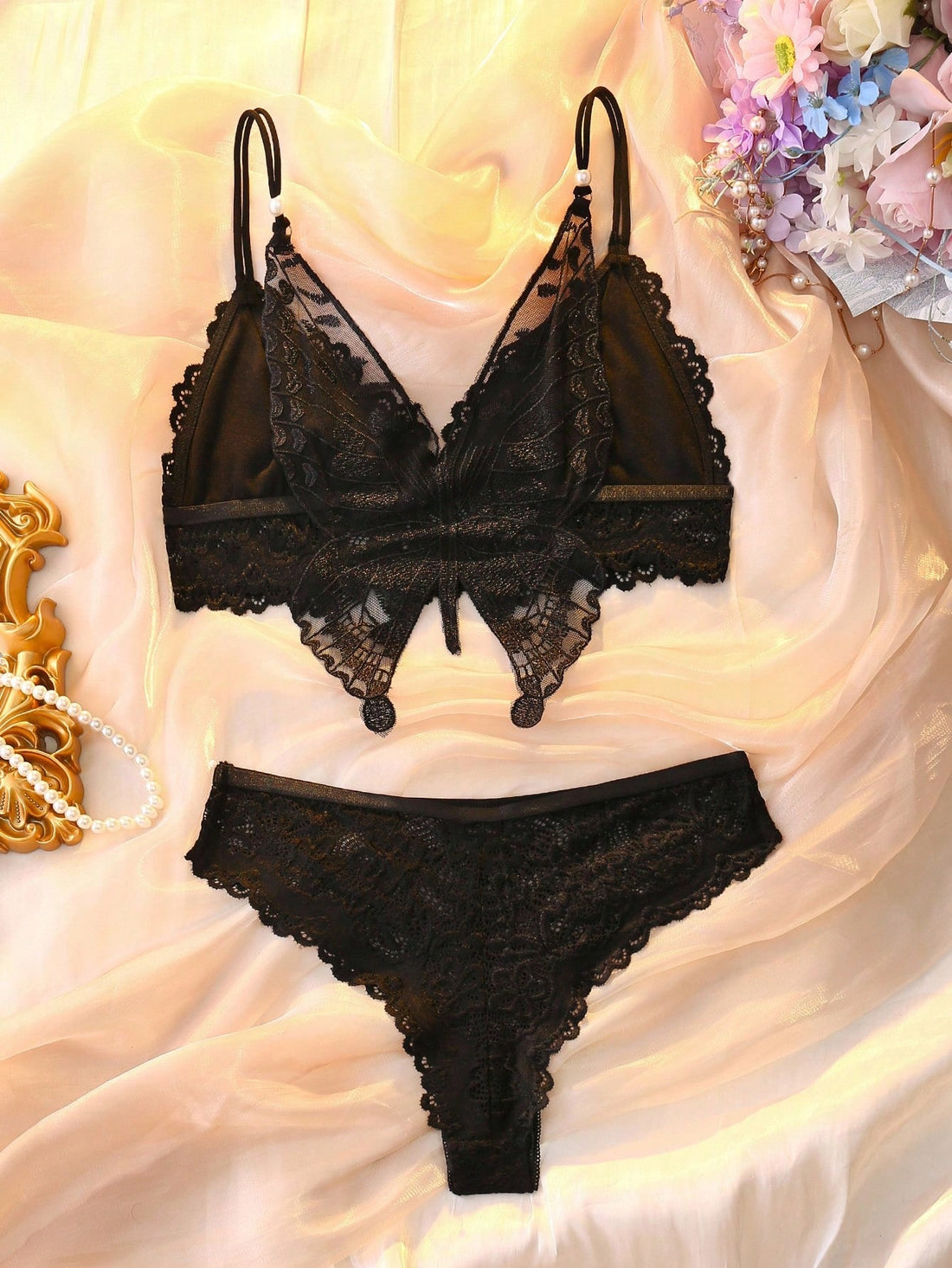 Two-piece floral lace lingerie set with butterfly decor, featuring a sheer unlined wireless backless bra with crossback straps and matching mid-rise brief panties.