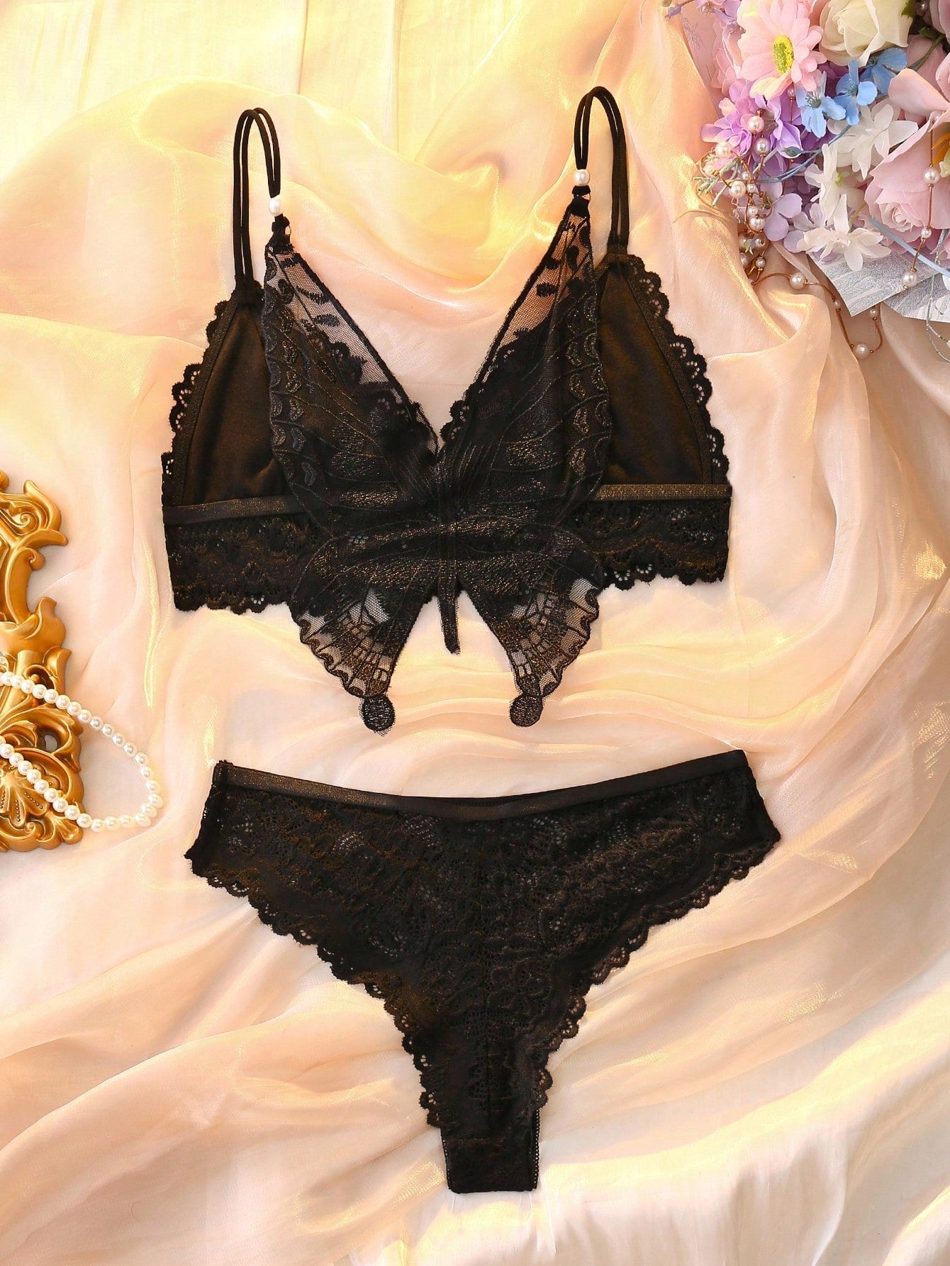 Two-piece floral lace lingerie set with butterfly decor, featuring a sheer unlined wireless backless bra with crossback straps and matching mid-rise brief panties.