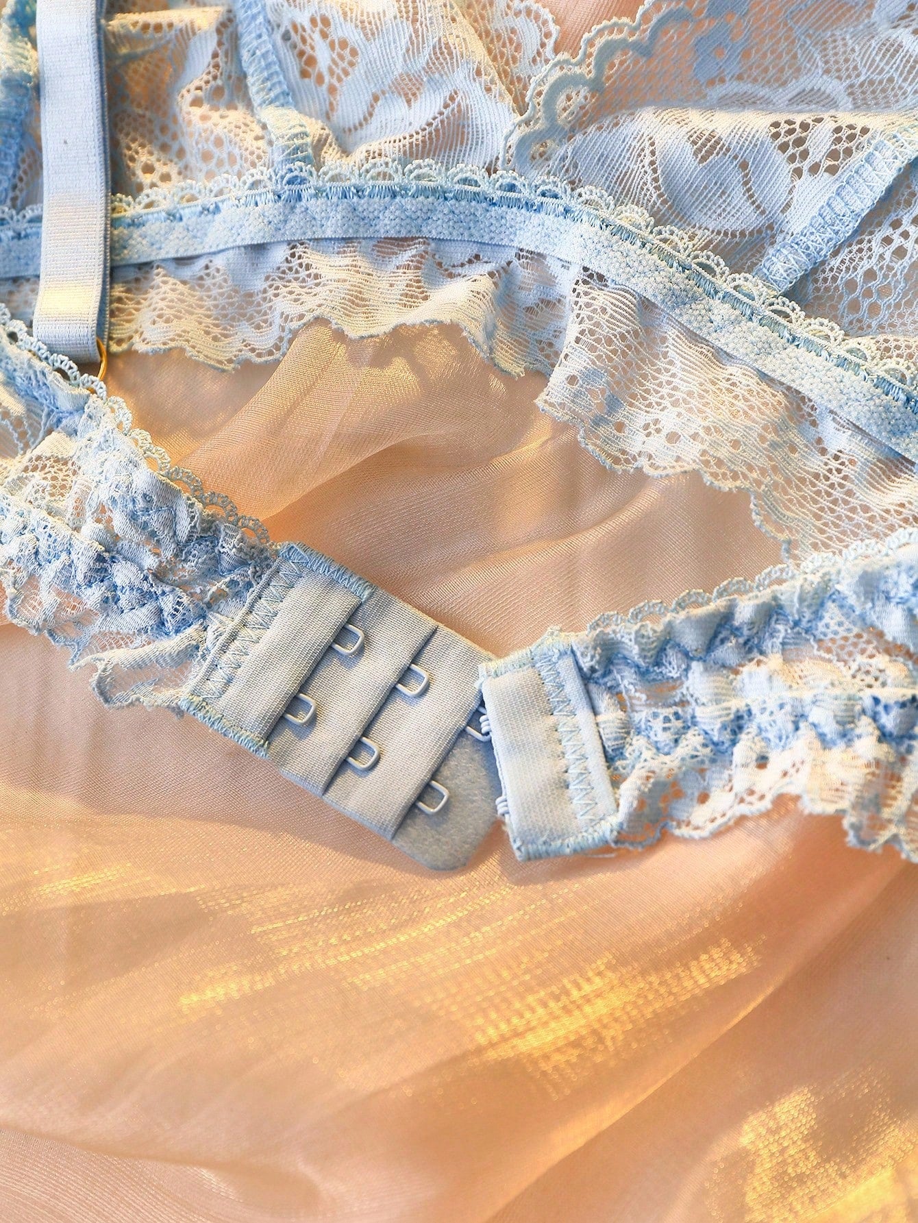 Women's floral lace lingerie set featuring a camisole-style wireless bra with adjustable straps and matching mid-rise briefs, designed with contrast scalloped lace and light support.
