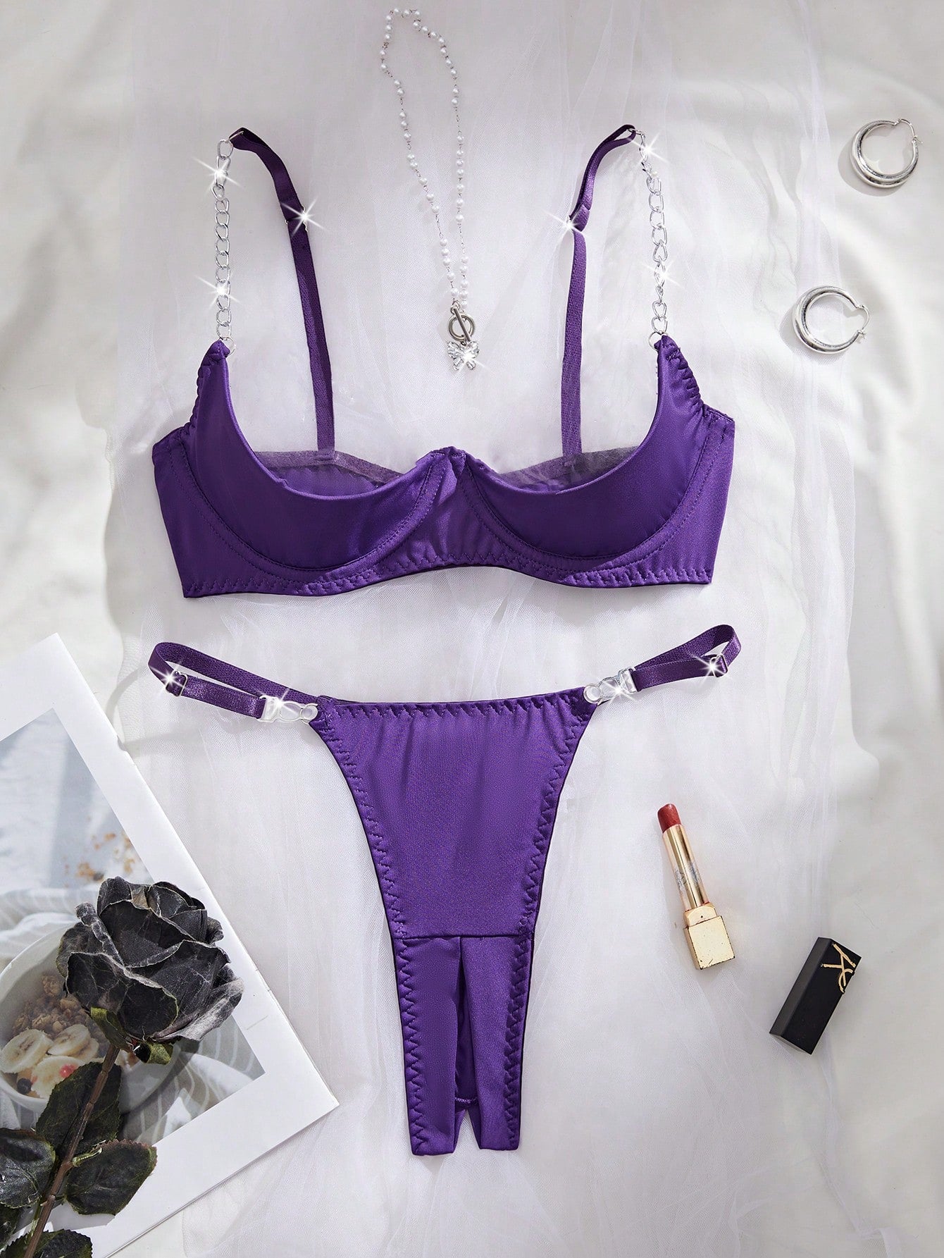 Two-piece women’s sexy lingerie set featuring an underwire lace top with adjustable shoulder straps and a matching low-rise thong, accented with a necklace detail.