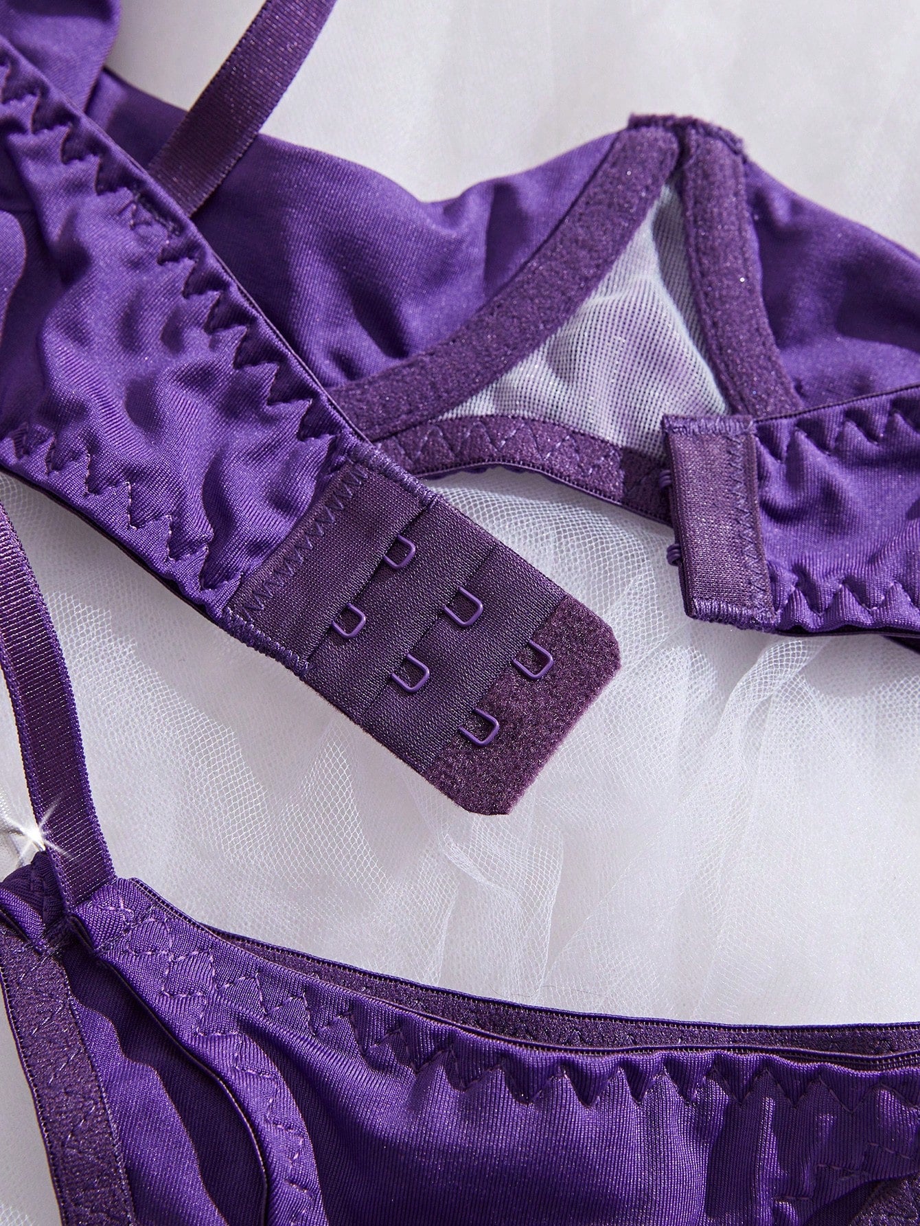 Two-piece women’s sexy lingerie set featuring an underwire lace top with adjustable shoulder straps and a matching low-rise thong, accented with a necklace detail.