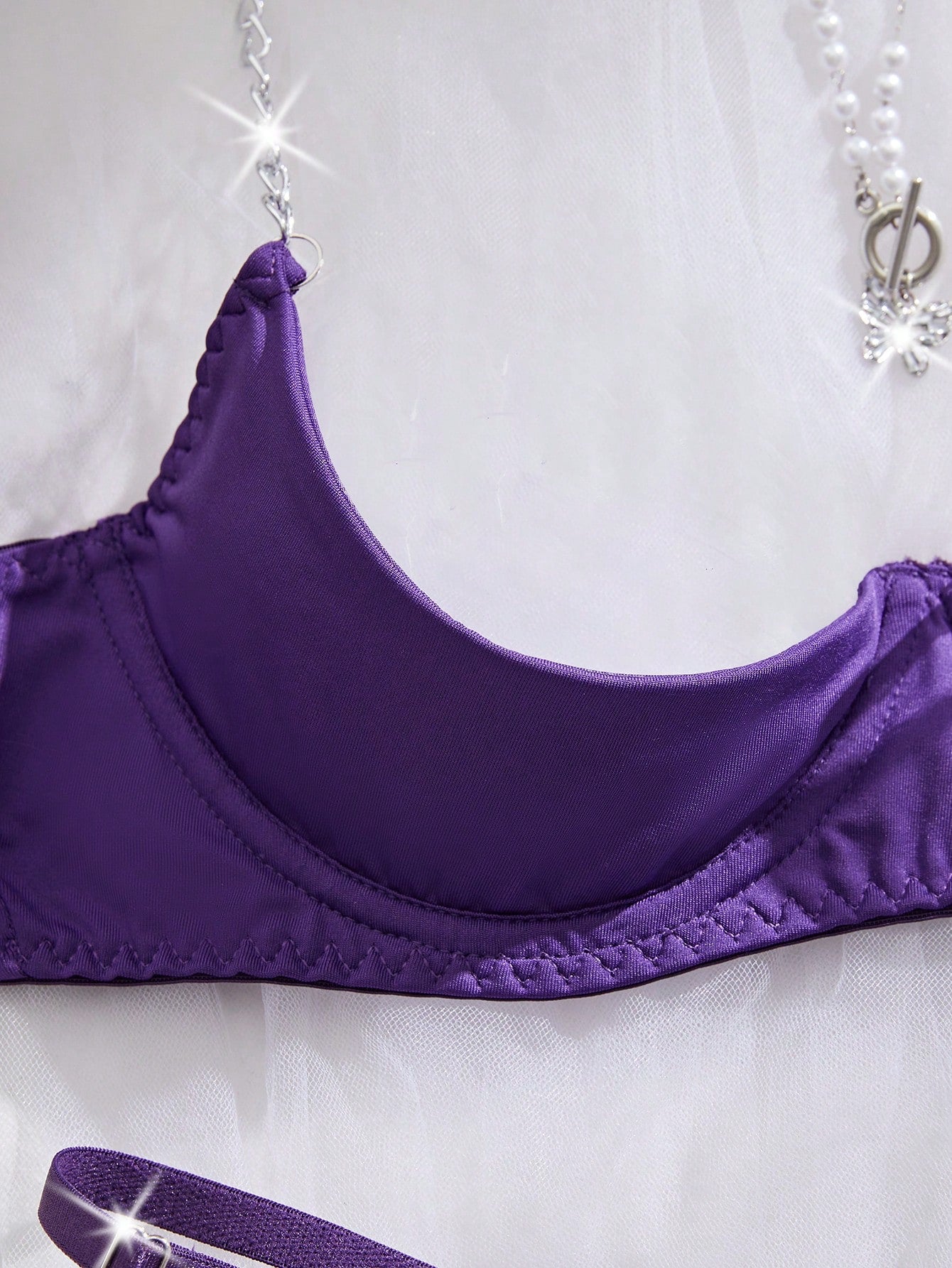 Two-piece women’s sexy lingerie set featuring an underwire lace top with adjustable shoulder straps and a matching low-rise thong, accented with a necklace detail.