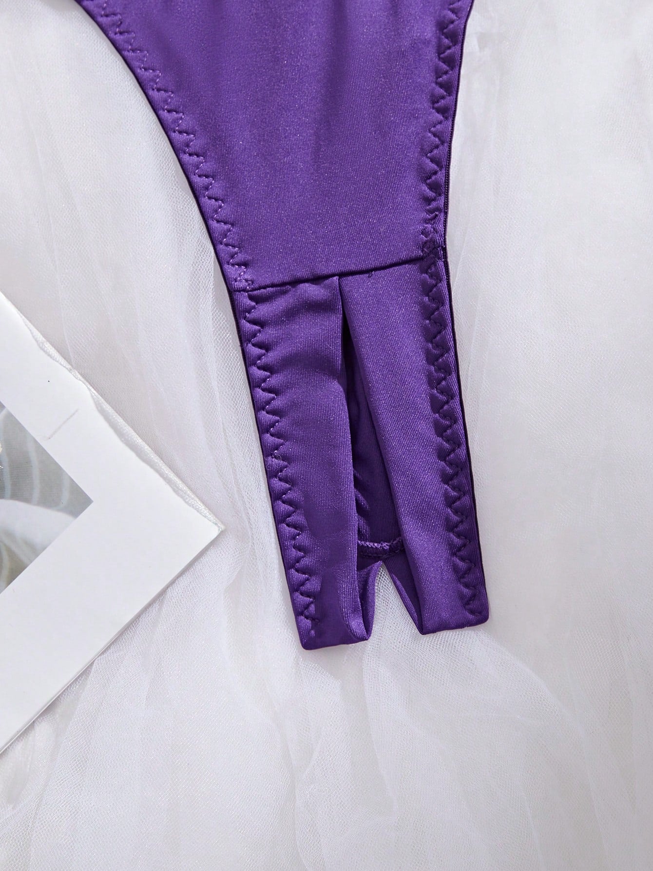 Two-piece women’s sexy lingerie set featuring an underwire lace top with adjustable shoulder straps and a matching low-rise thong, accented with a necklace detail.