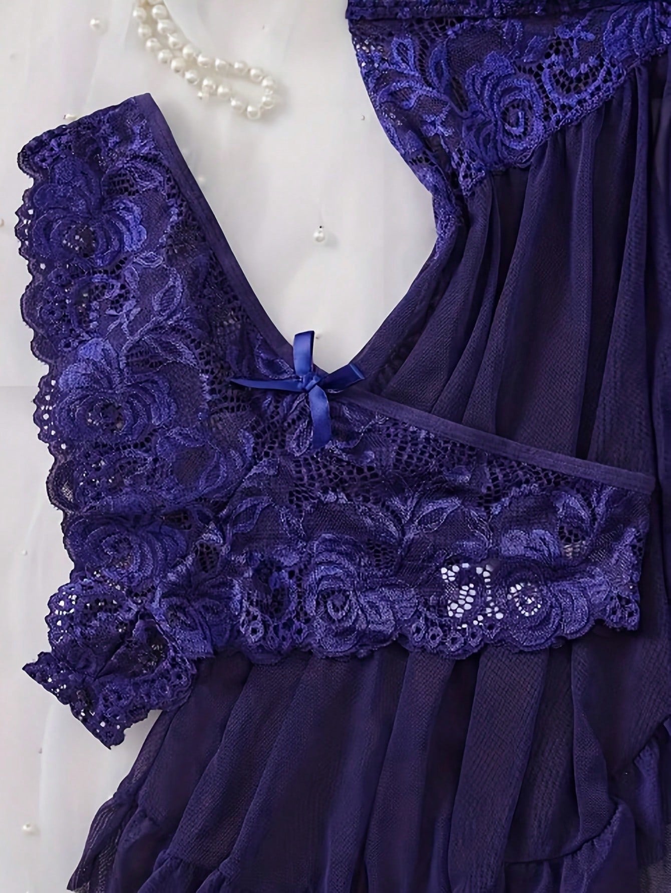 Women's 2-piece sexy lingerie set featuring a deep V sheer contrast lace babydoll bra with adjustable spaghetti straps and matching low-rise briefs; wireless plunge style with short sleeveless romantic design.