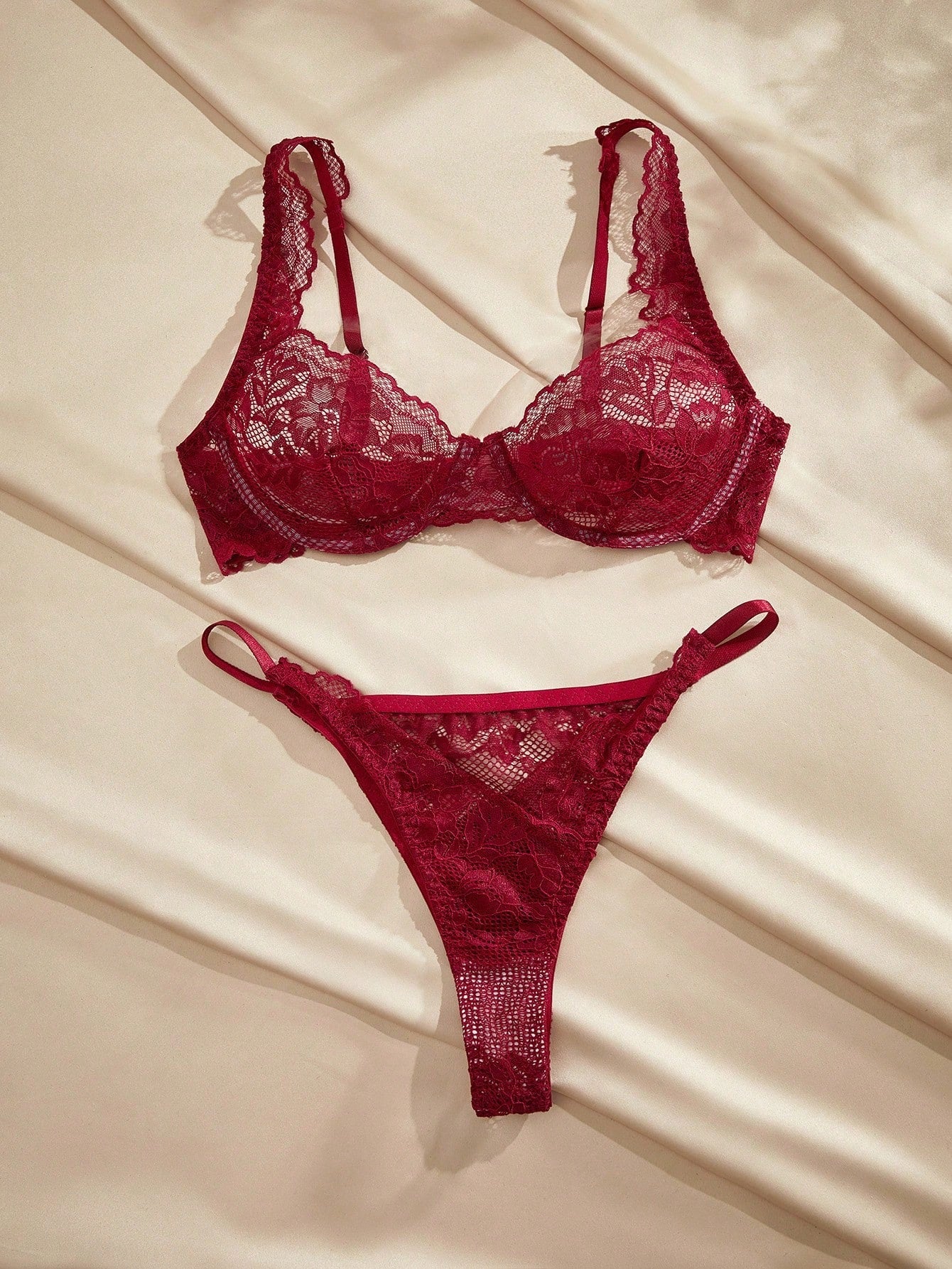 White lace underwire bra and matching thong lingerie set with adjustable spaghetti straps, triangle cups, and semi-sheer contrast lace details.