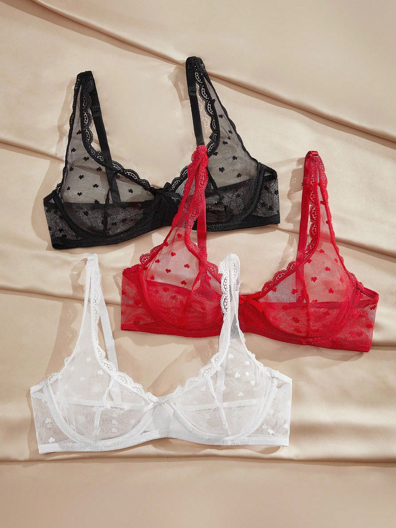 Women's solid color lace bra with sheer unlined design, bow detail, underwire support, and adjustable straps; romantic style push-up bralette for daily wear.