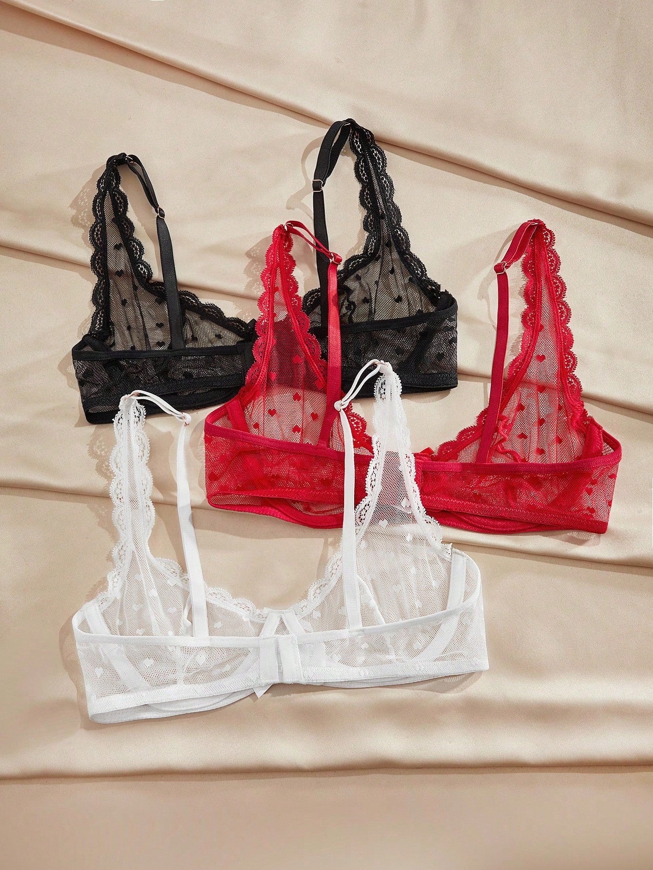 Women's solid color lace bra with sheer unlined design, bow detail, underwire support, and adjustable straps; romantic style push-up bralette for daily wear.