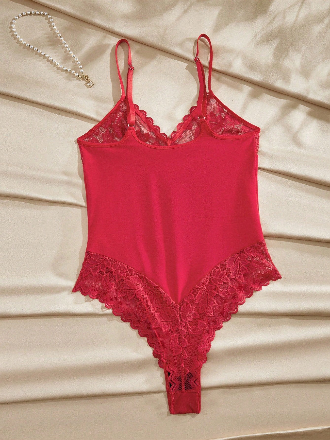 Women’s wireless floral lace sheer backless bodysuit with adjustable spaghetti straps, triangle cups, and brief-cut bottom.