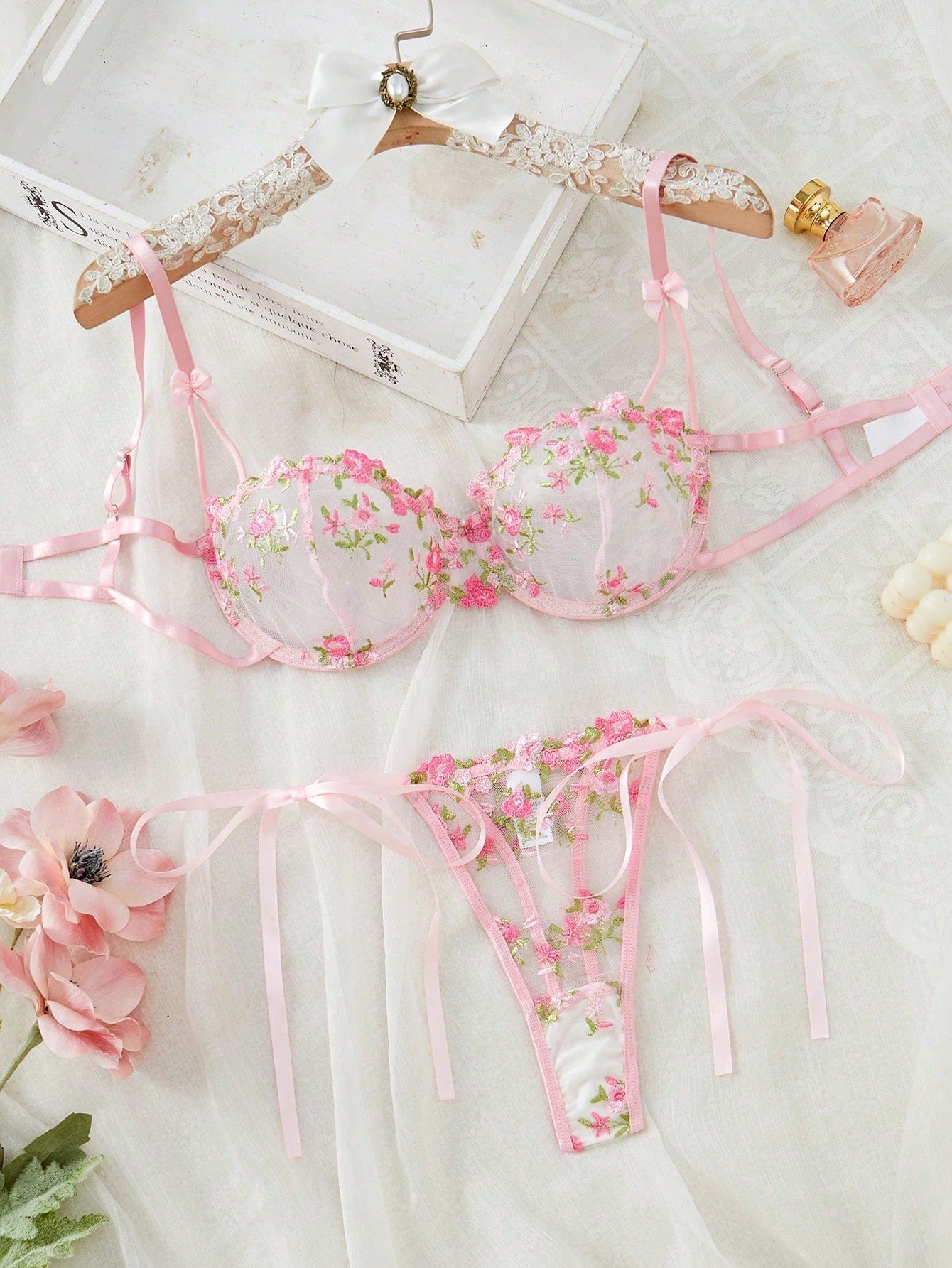 Pink women’s 2-piece lingerie set with floral embroidery and sheer mesh, featuring an underwire demi bra with adjustable spaghetti straps and a matching low-rise thong.