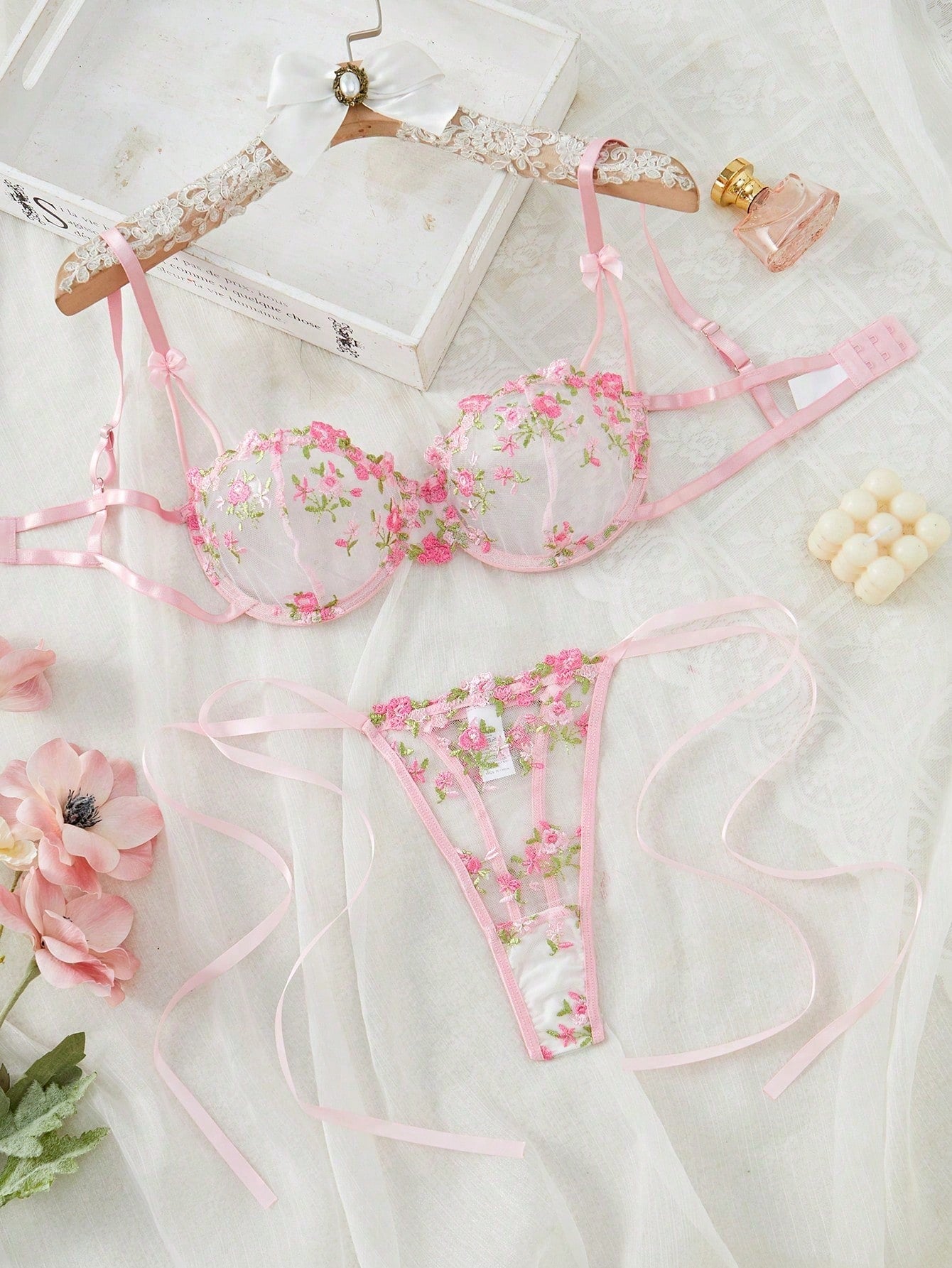 Pink women’s 2-piece lingerie set with floral embroidery and sheer mesh, featuring an underwire demi bra with adjustable spaghetti straps and a matching low-rise thong.