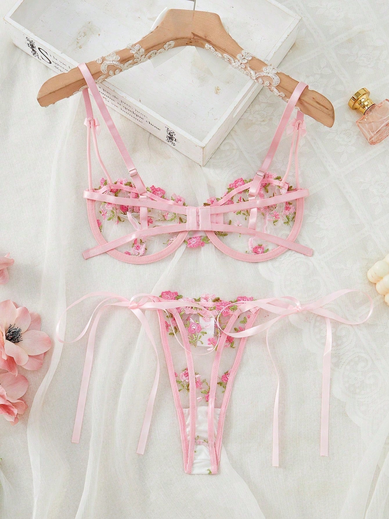 Pink women’s 2-piece lingerie set with floral embroidery and sheer mesh, featuring an underwire demi bra with adjustable spaghetti straps and a matching low-rise thong.