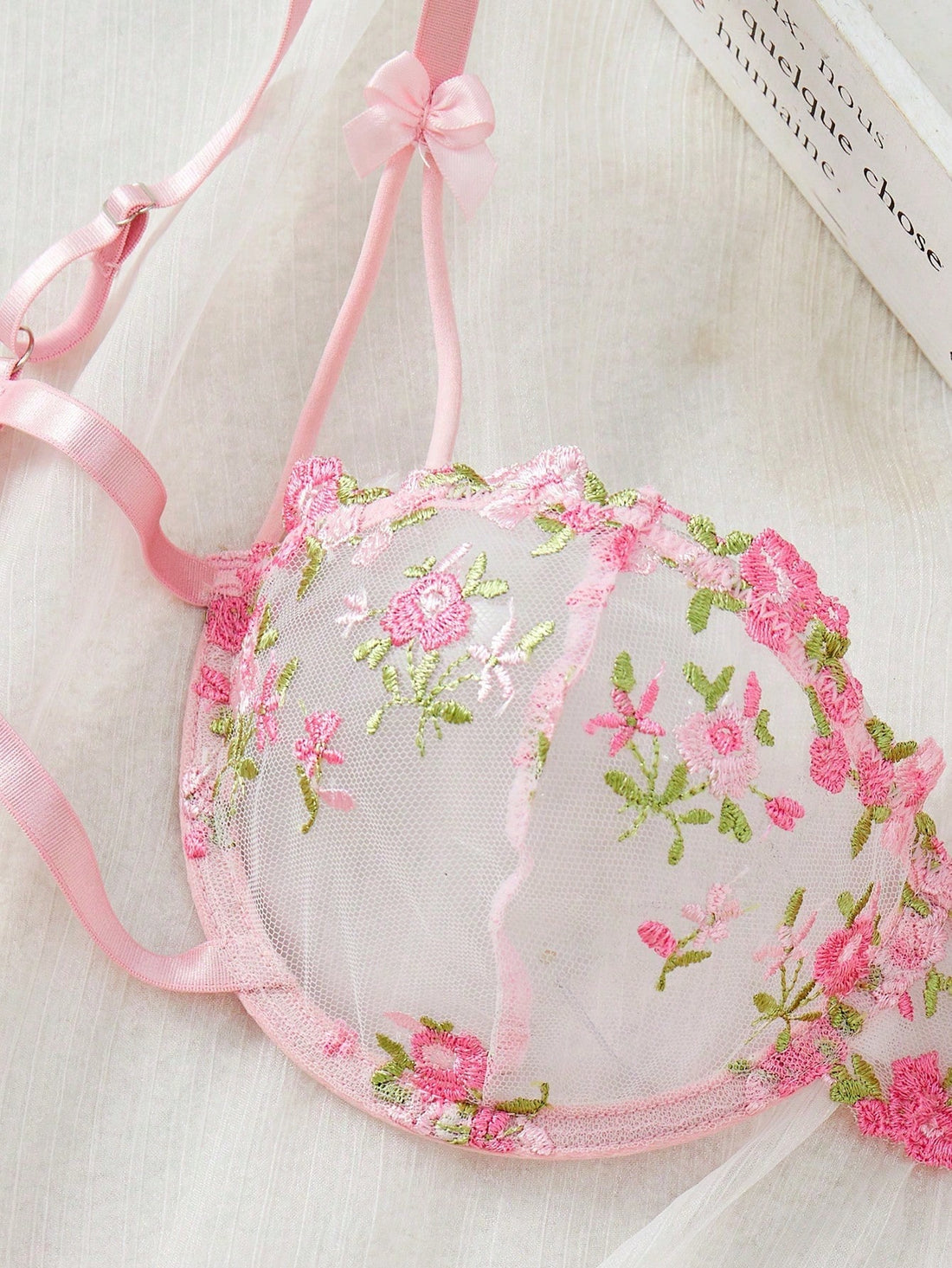 Pink women’s 2-piece lingerie set with floral embroidery and sheer mesh, featuring an underwire demi bra with adjustable spaghetti straps and a matching low-rise thong.