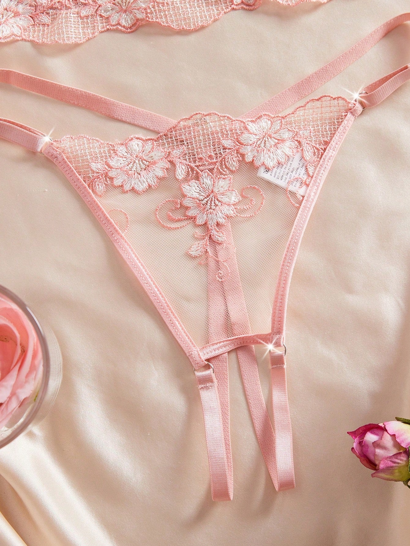 Two-piece women’s lingerie set with embroidered sheer fabric, hollow-out cutout details, underwire demi bra with adjustable spaghetti straps, and matching low-rise thong.