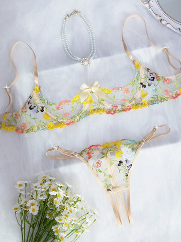 Two-piece women’s lingerie set with floral embroidery and sheer mesh, featuring an underwire spaghetti-strap top with adjustable straps and matching low-rise thong panty in a multicolor pattern.