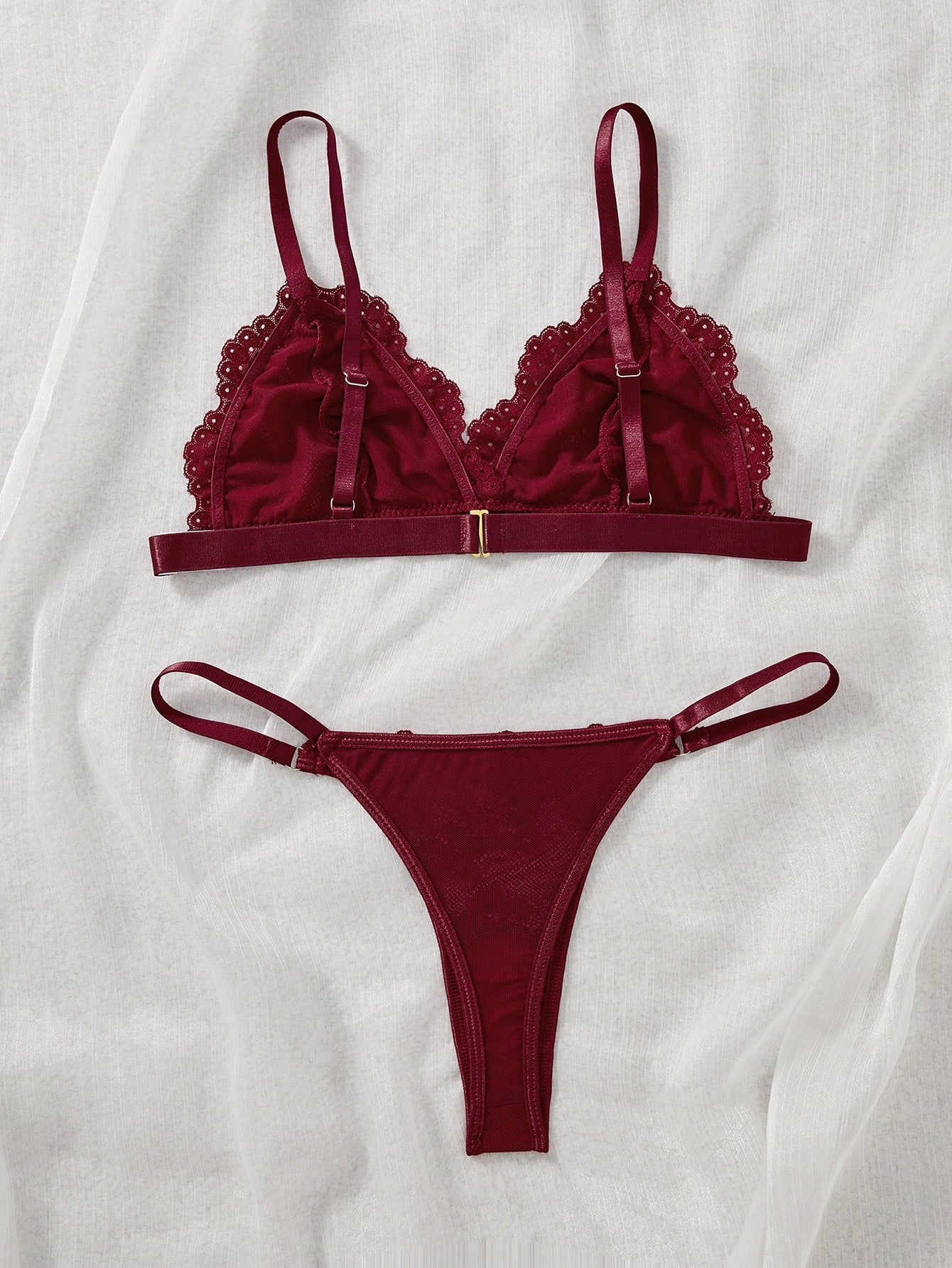 Women's 2-piece lingerie set with a solid color lace patchwork cami bralette featuring spaghetti straps and a crossback design, paired with a matching low-rise thong panty.