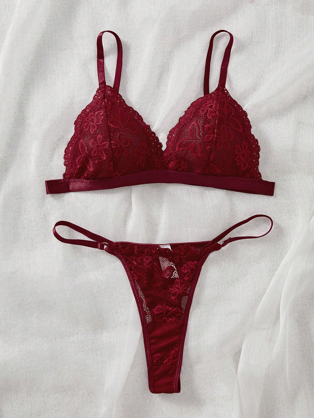Women's 2-piece lingerie set with a solid color lace patchwork cami bralette featuring spaghetti straps and a crossback design, paired with a matching low-rise thong panty.