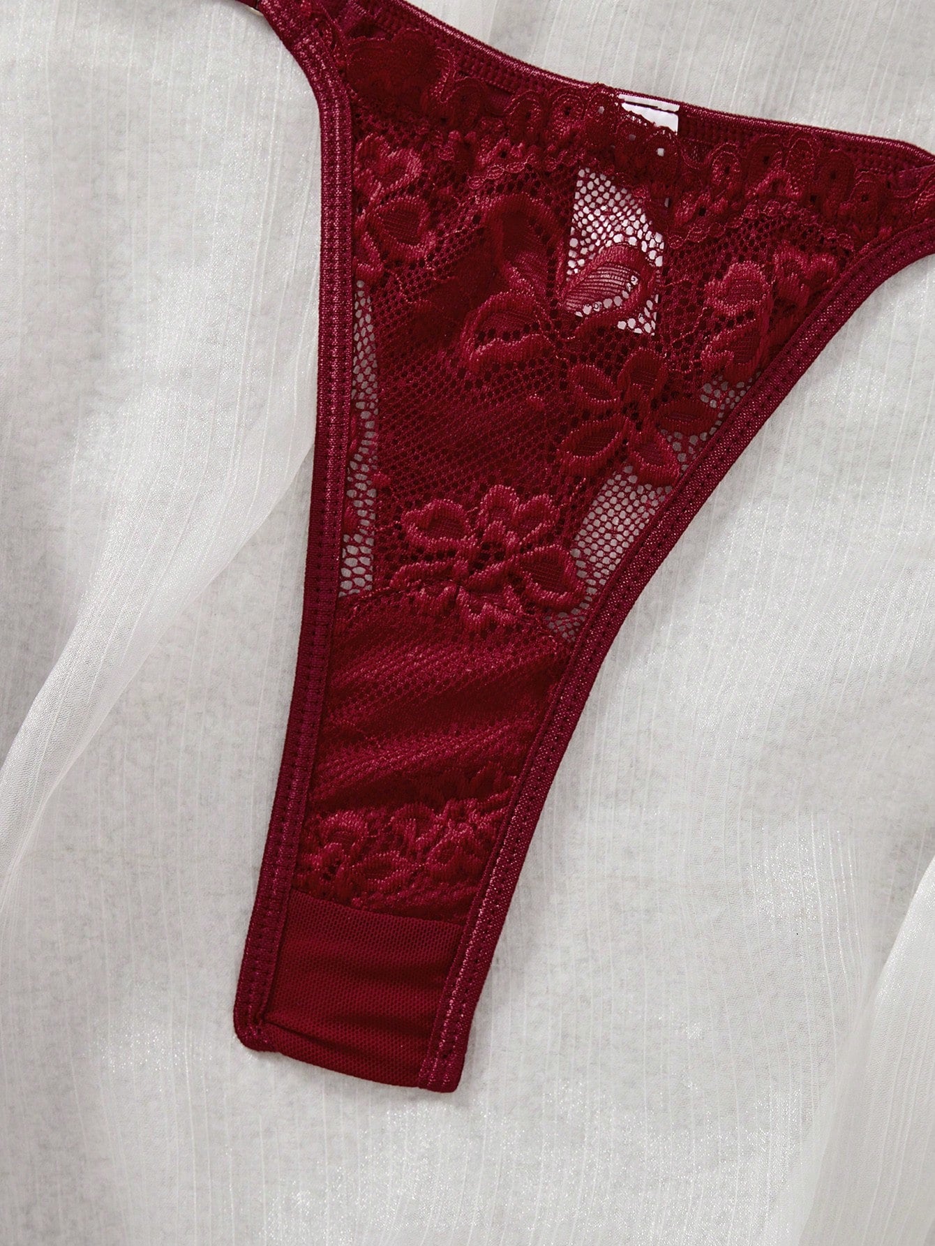 Women’s 2-piece lace patchwork solid-color lingerie set with a spaghetti-strap crossback bralette and low-rise thong panty, styled for romantic or festival looks.