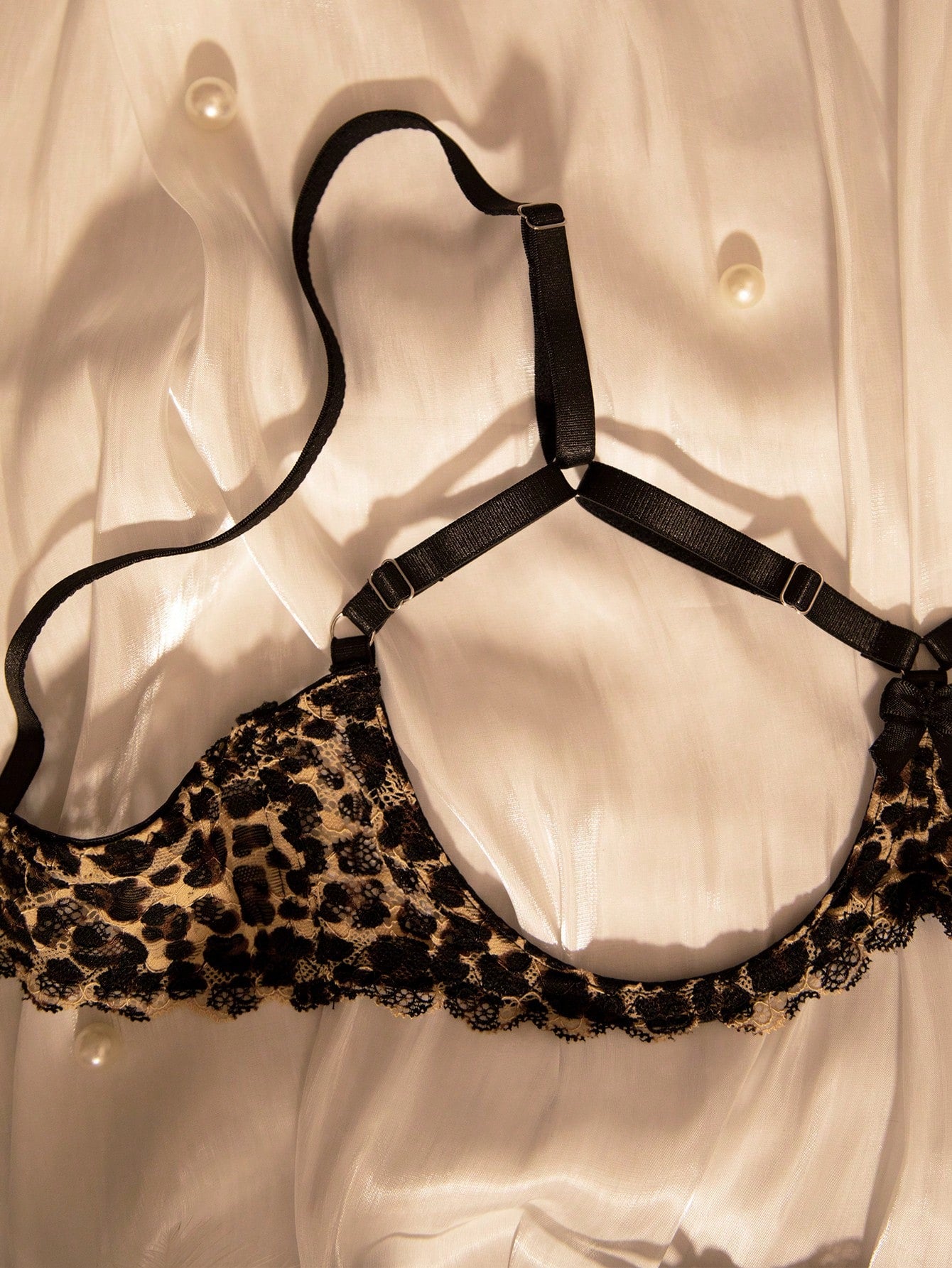 Two-piece women’s sexy lingerie set with goth leopard print, lace patchwork, mesh details, adjustable spaghetti straps, underwire top, and low-rise V-string crotchless panties.