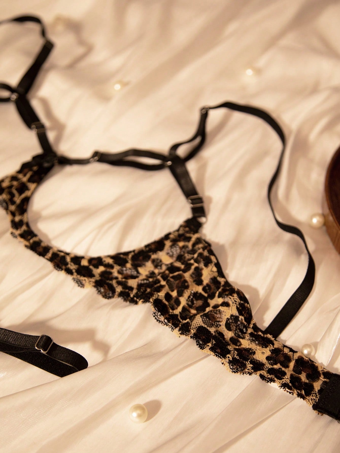 Two-piece women’s sexy lingerie set with goth leopard print, lace patchwork, mesh details, adjustable spaghetti straps, underwire top, and low-rise V-string crotchless panties.