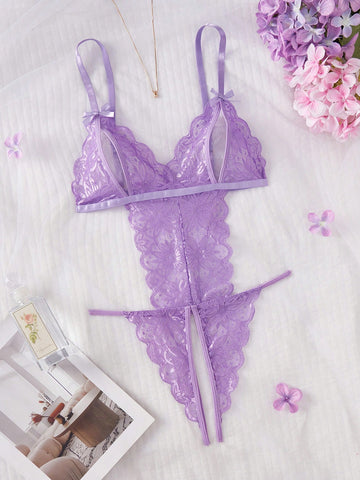 Purple women's sexy lingerie bodysuit with deep V-neck, sheer contrast floral lace, hollow-out details, bow decor, adjustable spaghetti straps, backless design, and crotchless thong-style bottom.
