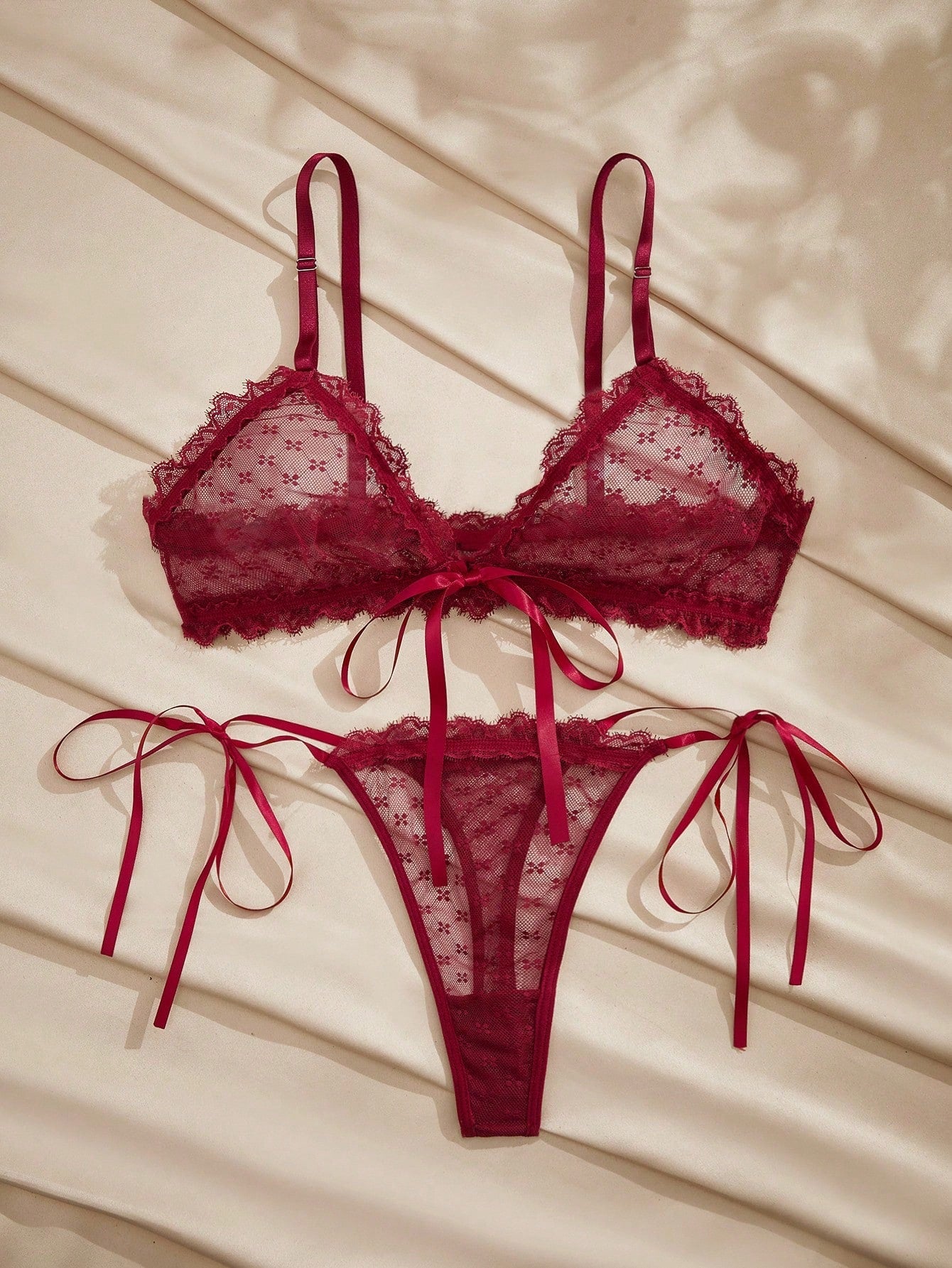 French minimalist 2-piece lingerie set with a sheer wireless bralette featuring contrast lace trim and knot detail, plus a matching mid-rise thong with medium-stretch fabric and adjustable straps.
